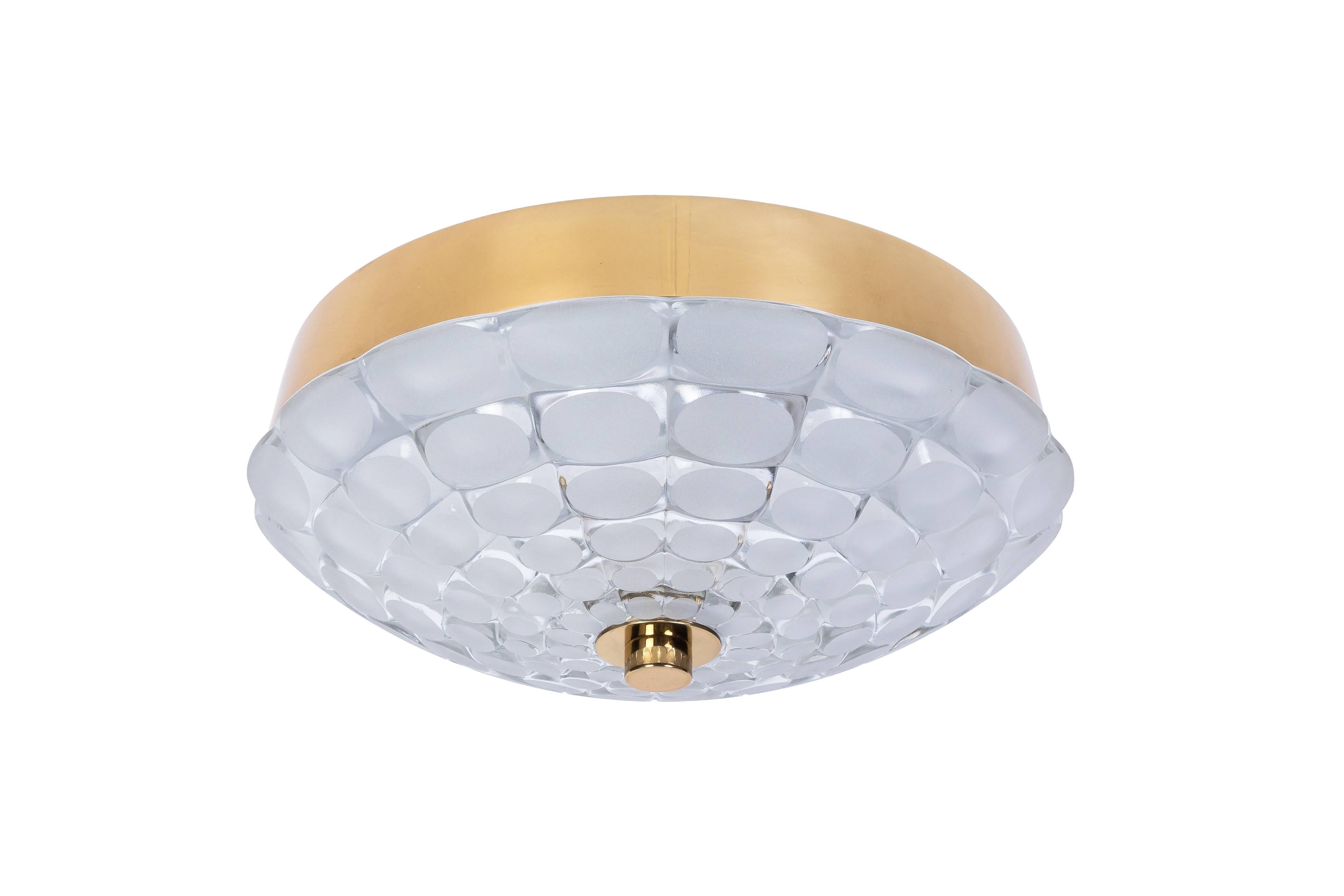 This gorgeous Mid-Century Modernist sconce or wall ceiling flush mount was designed by Kalmar. It features a brass frame and frosted curved cut-glass shades.