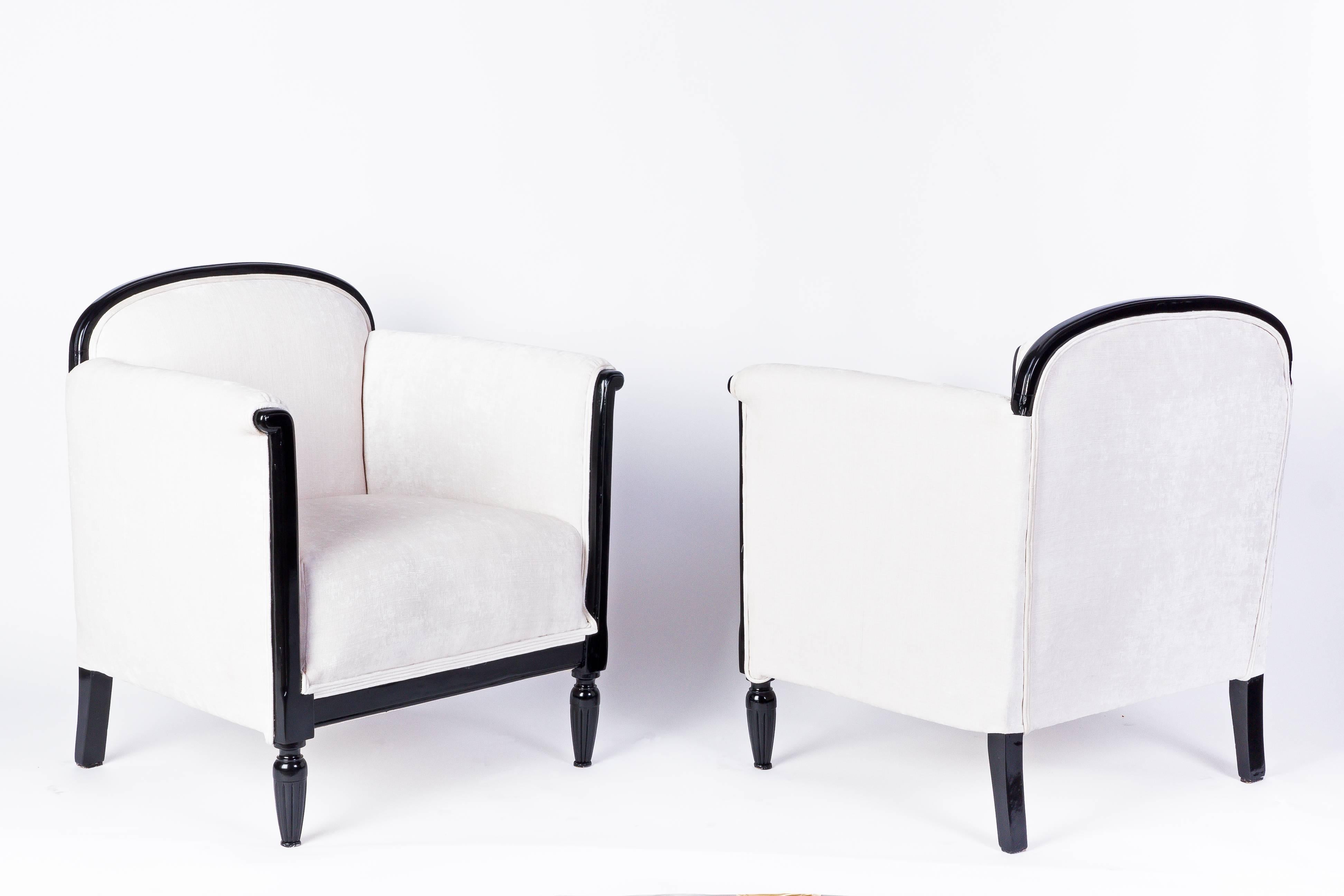 This exceptional pair of early Art Deco armchairs feature in ebonized solid Mahogany frame and a luscious of white cotton/velvet fabric.