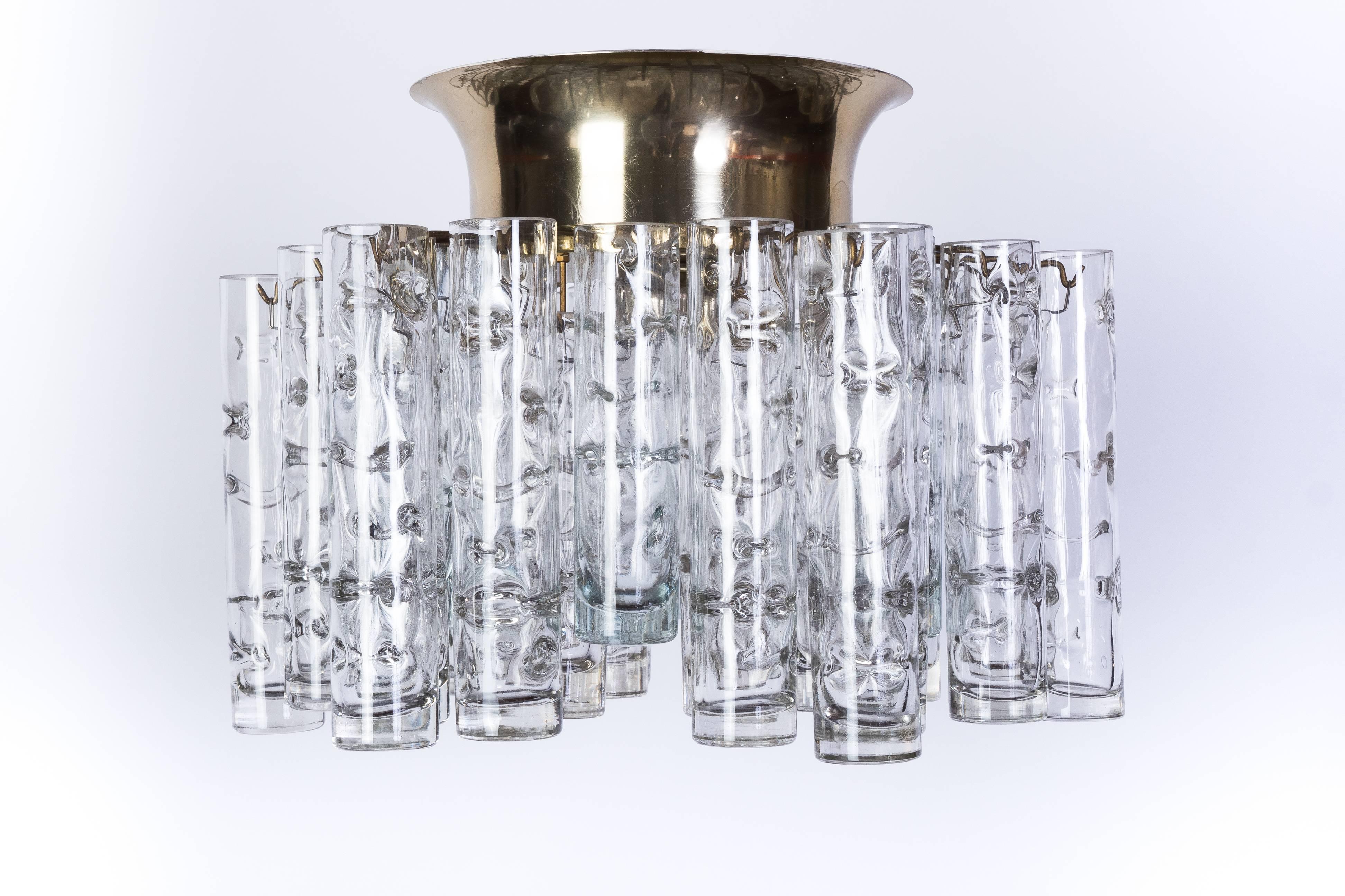 This exceptional German 1950s flush mount was designed by Doria. It features 30 handblown textured glass tubes cascading from a circular brass frame. It is in excellent condition and has been newly rewired.