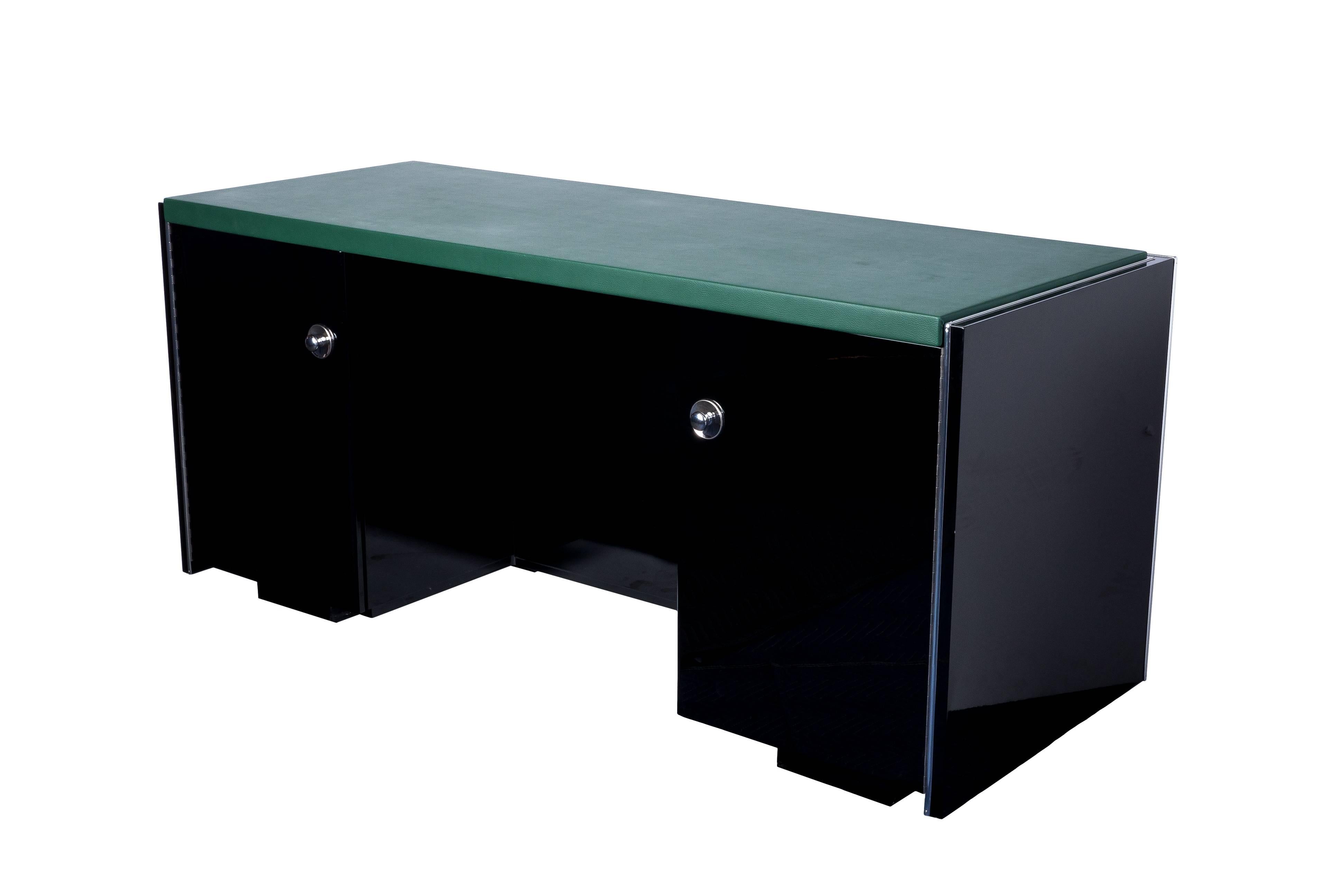 This magnificent Art Deco desk features a classic square design with a top leather-plate in moss. It is fully functional on both sides finished in a high gloss black lacquer with chrome detailing and fixtures.

Made in France, circa 1930.