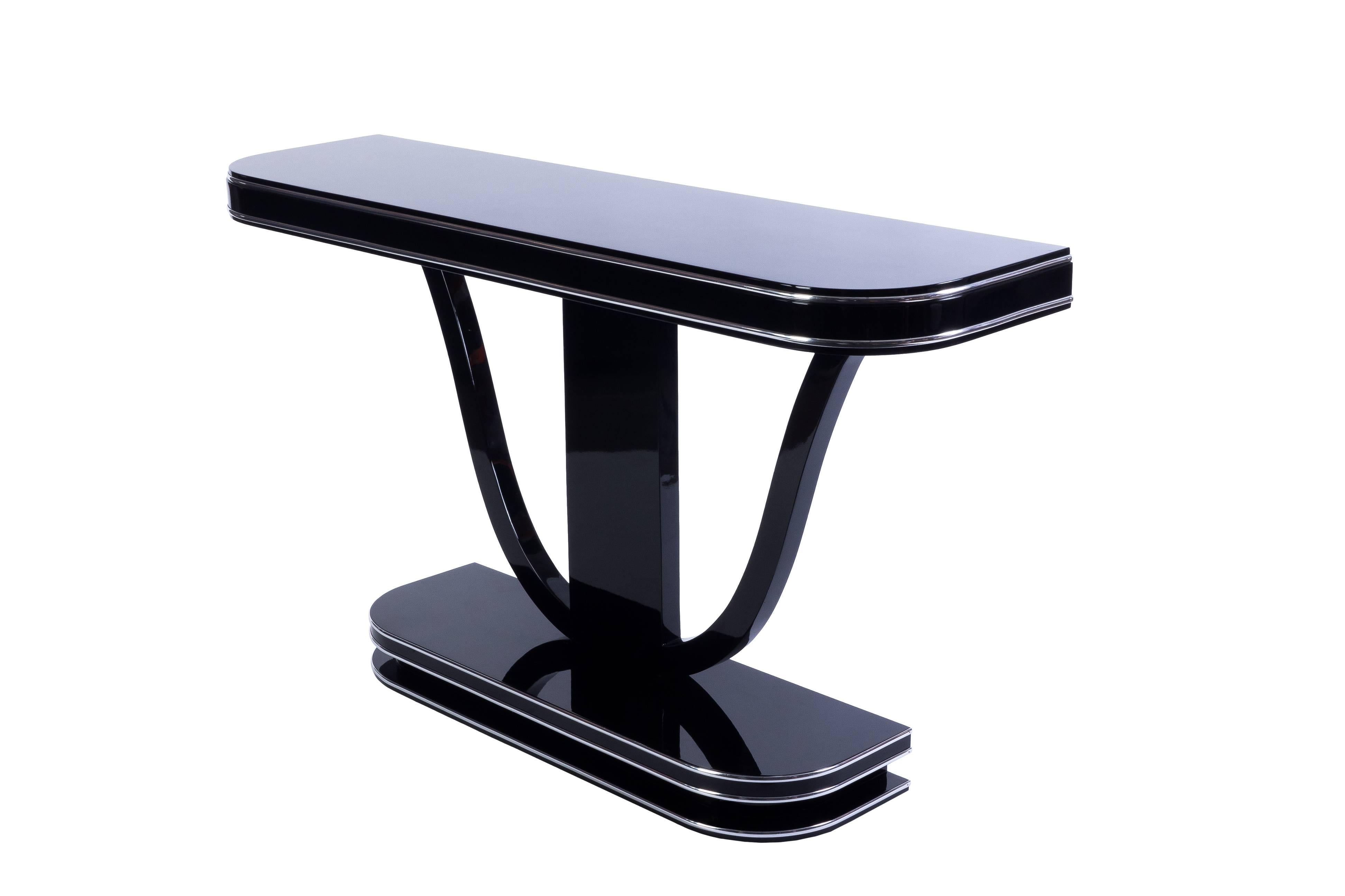 This superb French Art Deco style console features a high gloss black lacquer finish with curved detailing and chrome line details.