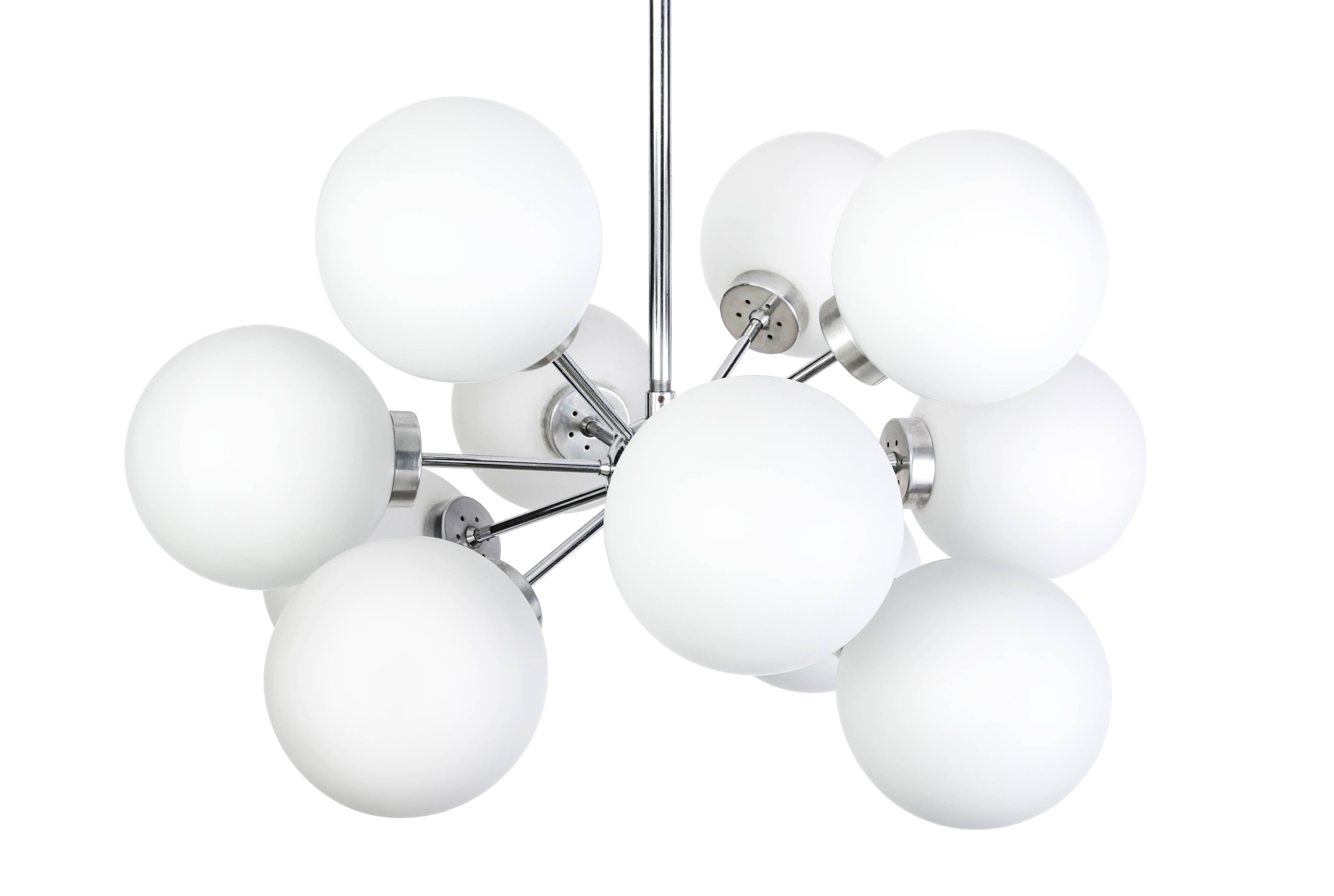 This gorgeous Mid-Century Modernist chandelier was designed by Richard Essig. It features a chrome base with twelve (12) crystal opal glass globes creating a cluster form design.
 