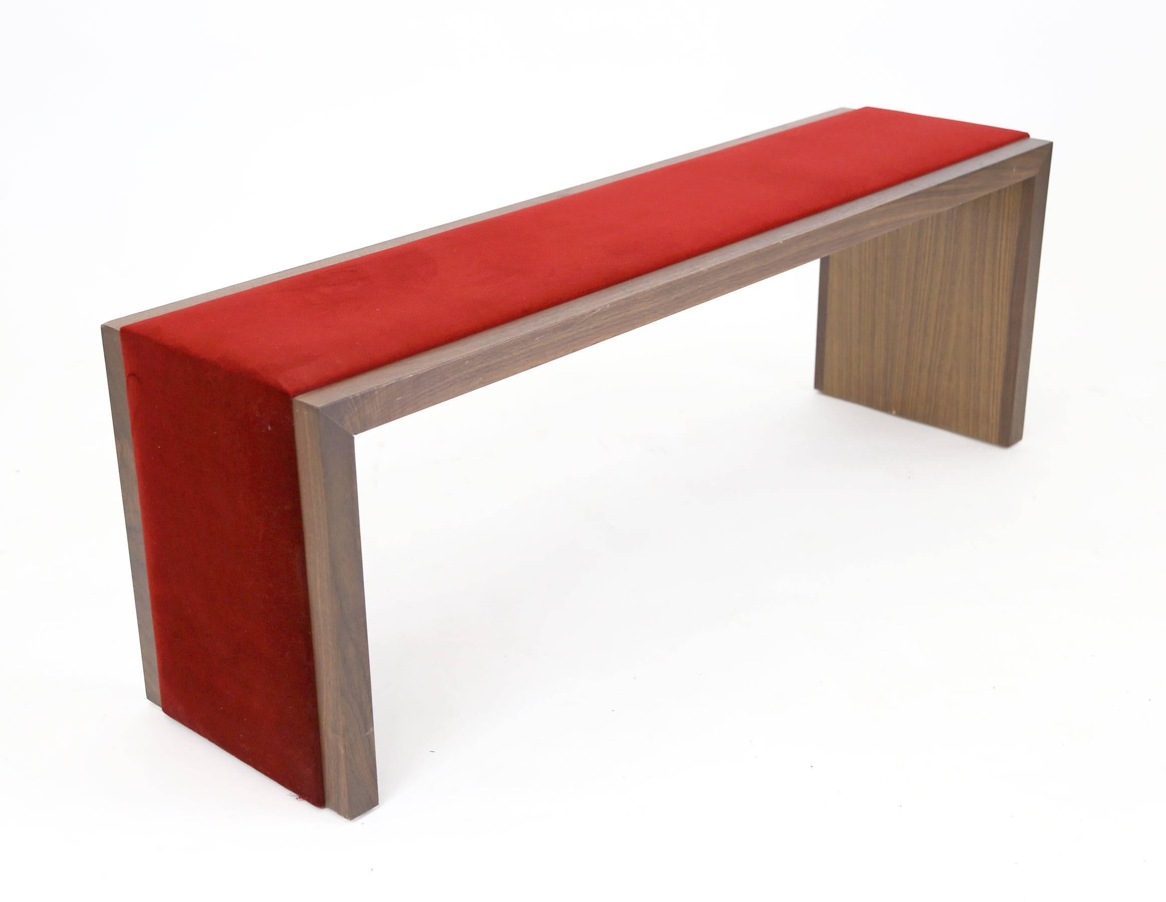 Walnut bench with a red velvet strip running across the seat and down both legs for a luxurious and interesting touch. Mitred corners, solid wood and underside is walnut veneer.