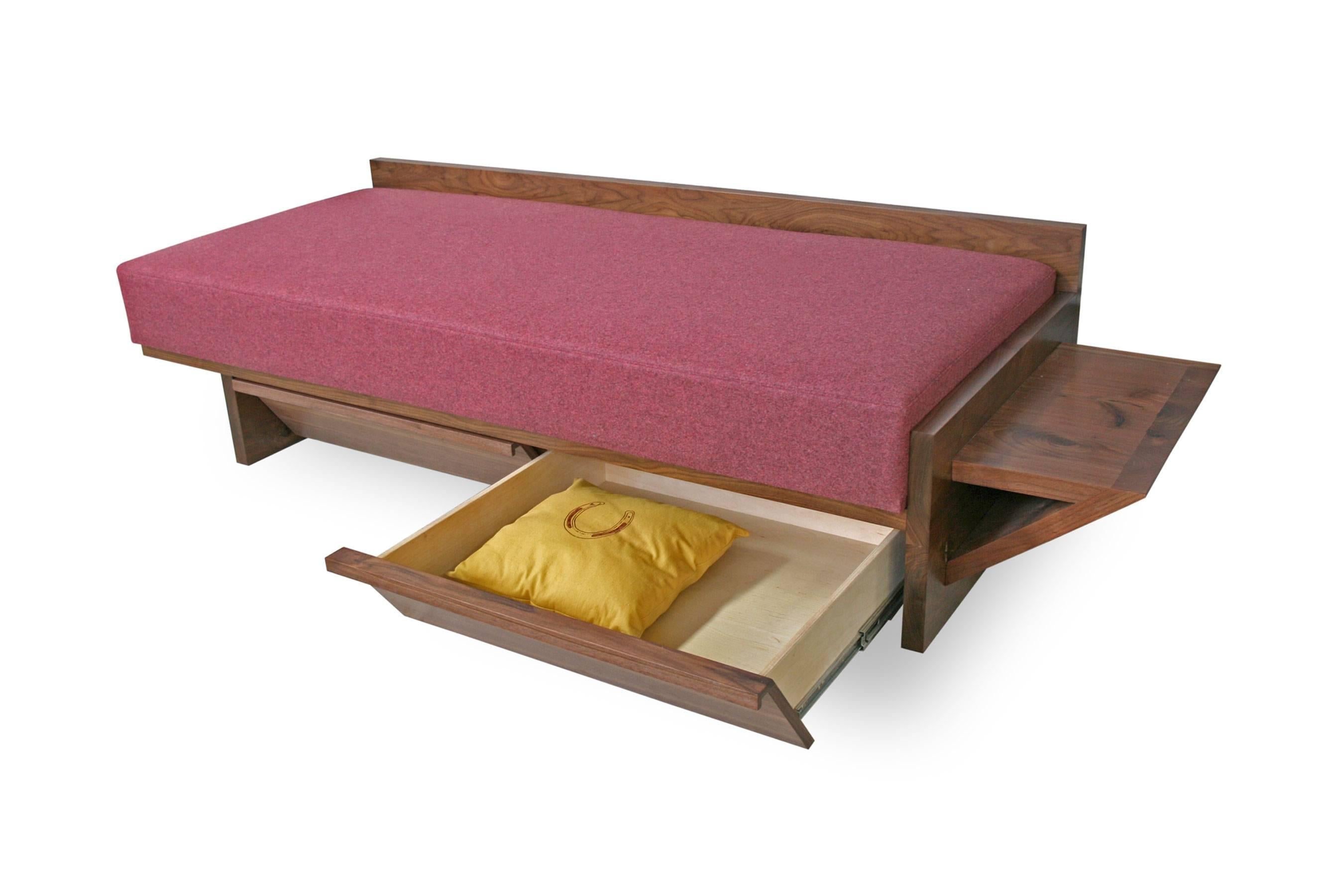 Form meets function in this contemporary design featuring a storage shelf and two hidden storage drawers underneath. The upholstered daybed is in the same dimensions as a twin mattress for putting up guests.

Shown in walnut hardwood and upholstered