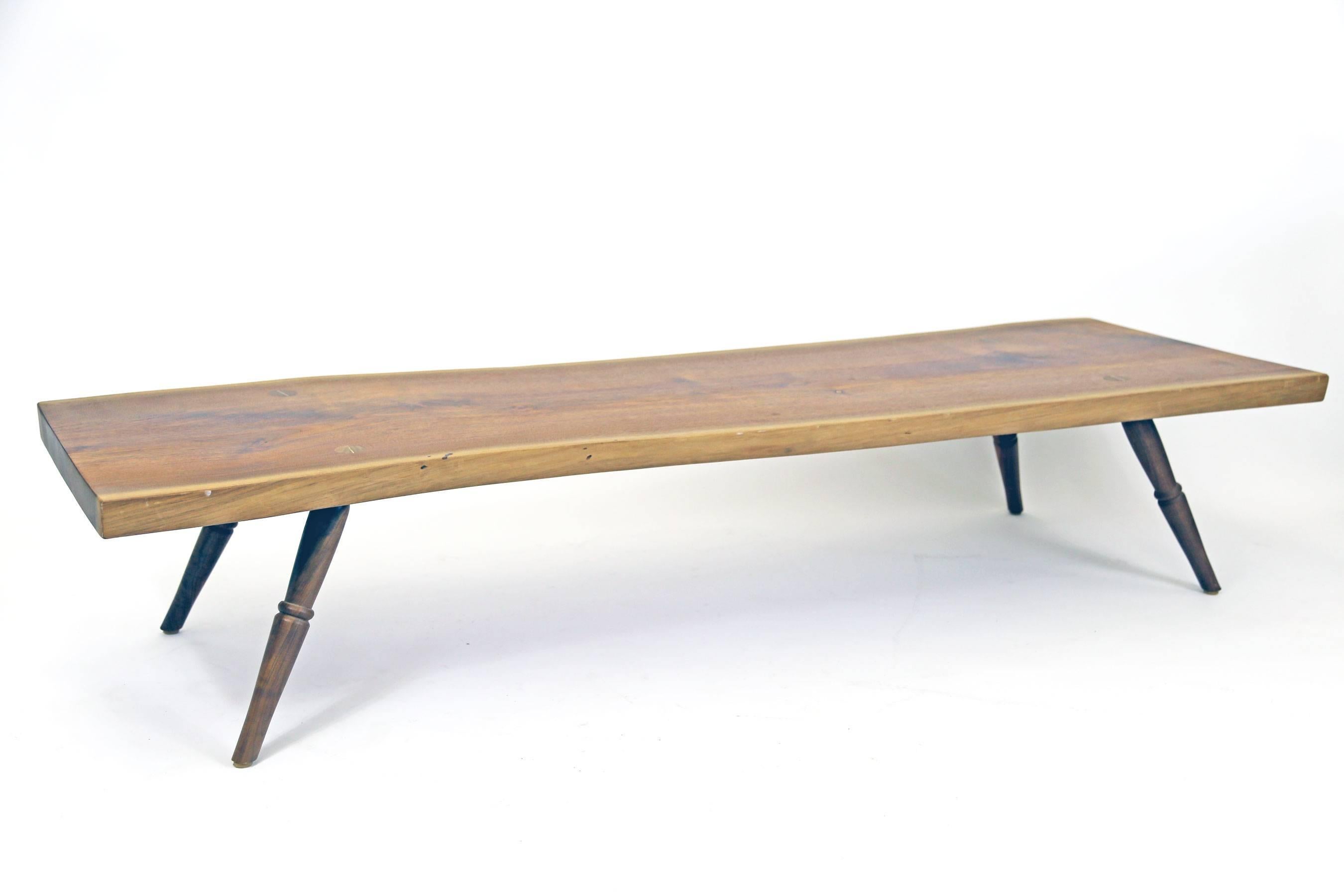 Relatively long coffee table featuring a live edge slab sourced from Pennsylvania, with hand-turned legs. Made by Amish woodworkers.

Floor model in like new condition. One of a kind.