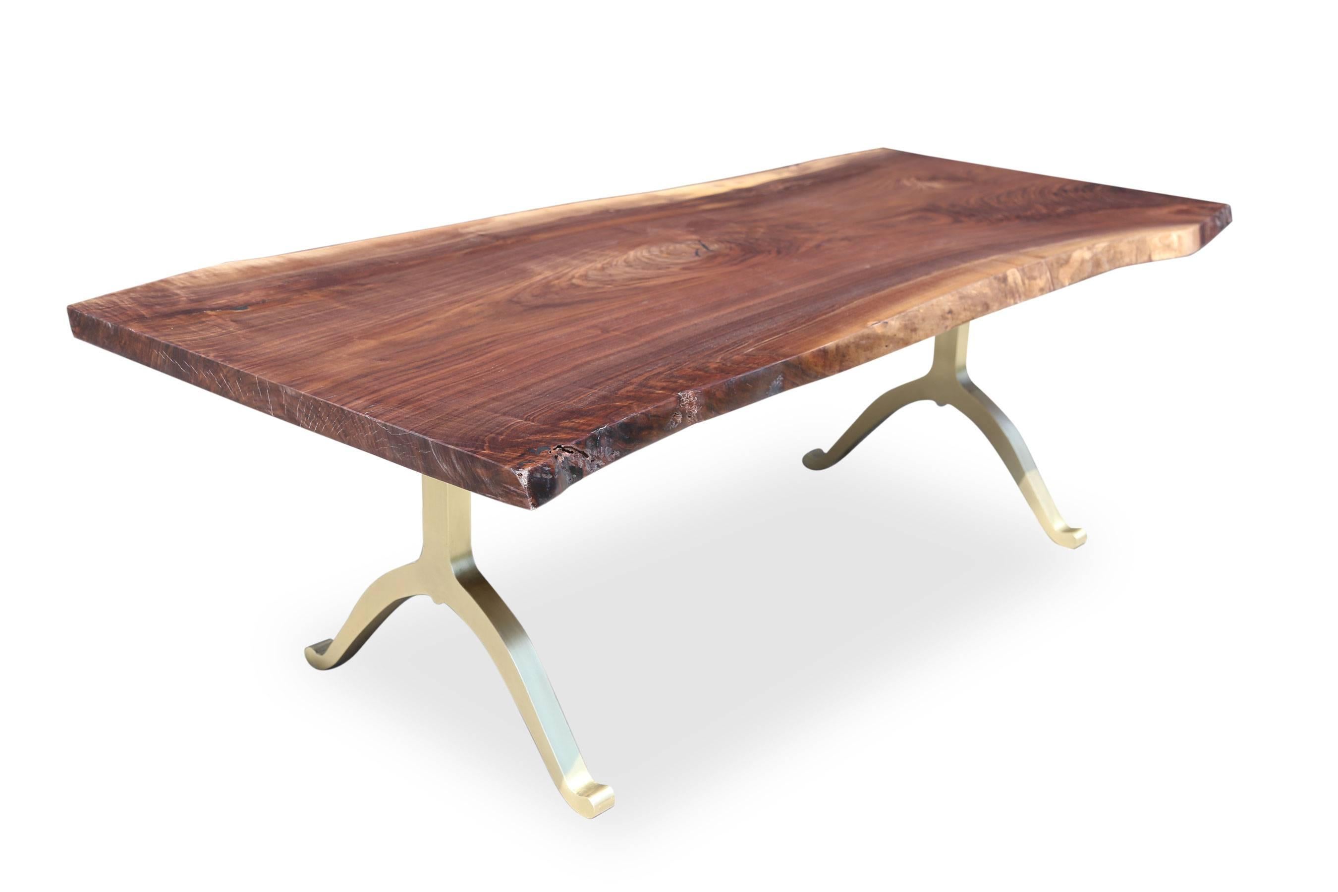 Solid American black walnut live edge tabletop paired with our solid brass wishbone legs. 

Our tables let the walnut grain speak for itself with a durable clear coat finish over the wood with no stain. Our work has been featured in some of the most