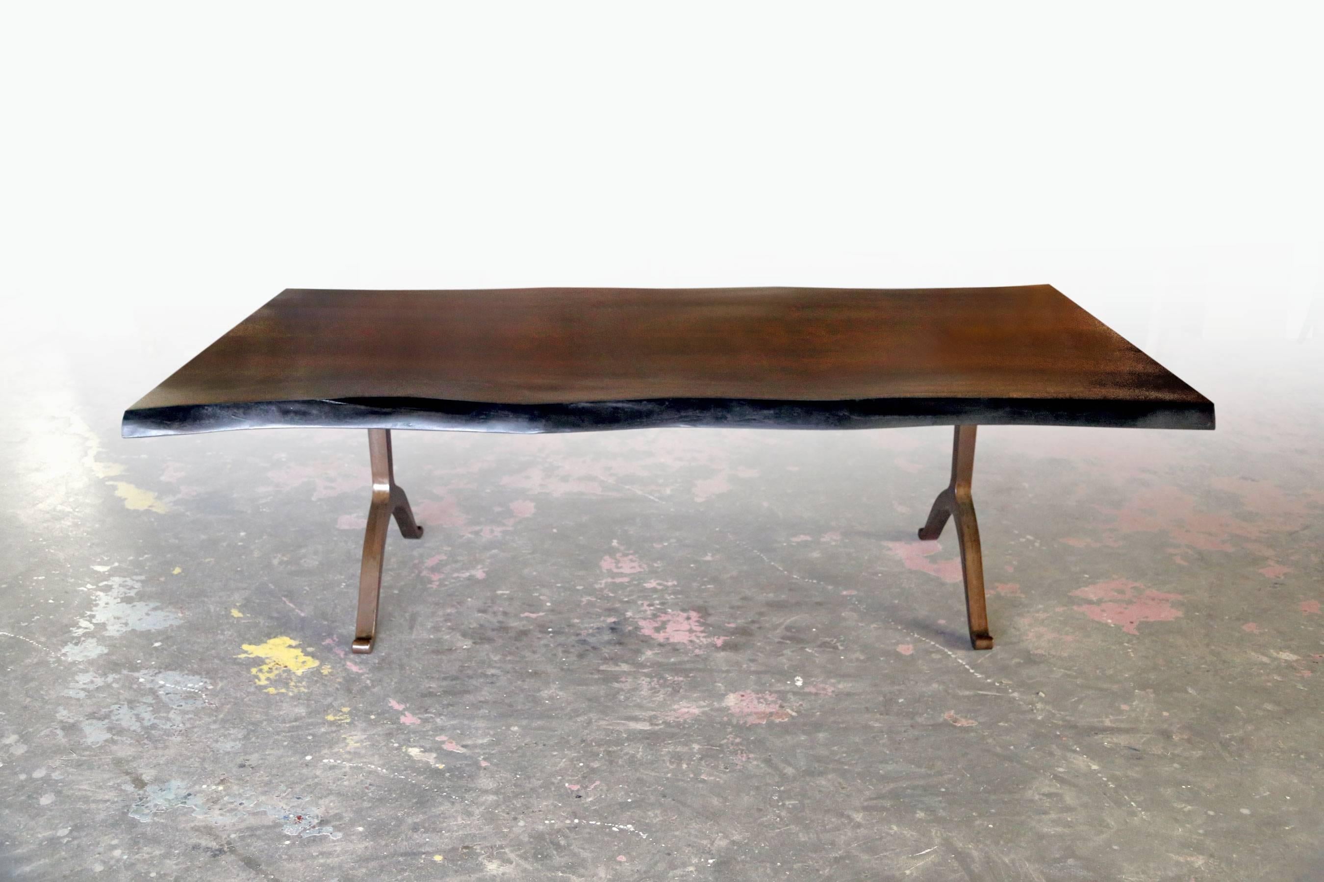 Solid American black walnut live edge tabletop paired with our solid bronzed steel wishbone legs at 84 x 36 and 30 inches tall. 

Our tables let the walnut grain speak for itself with a durable clear coat finish over the wood and no stain. Our work