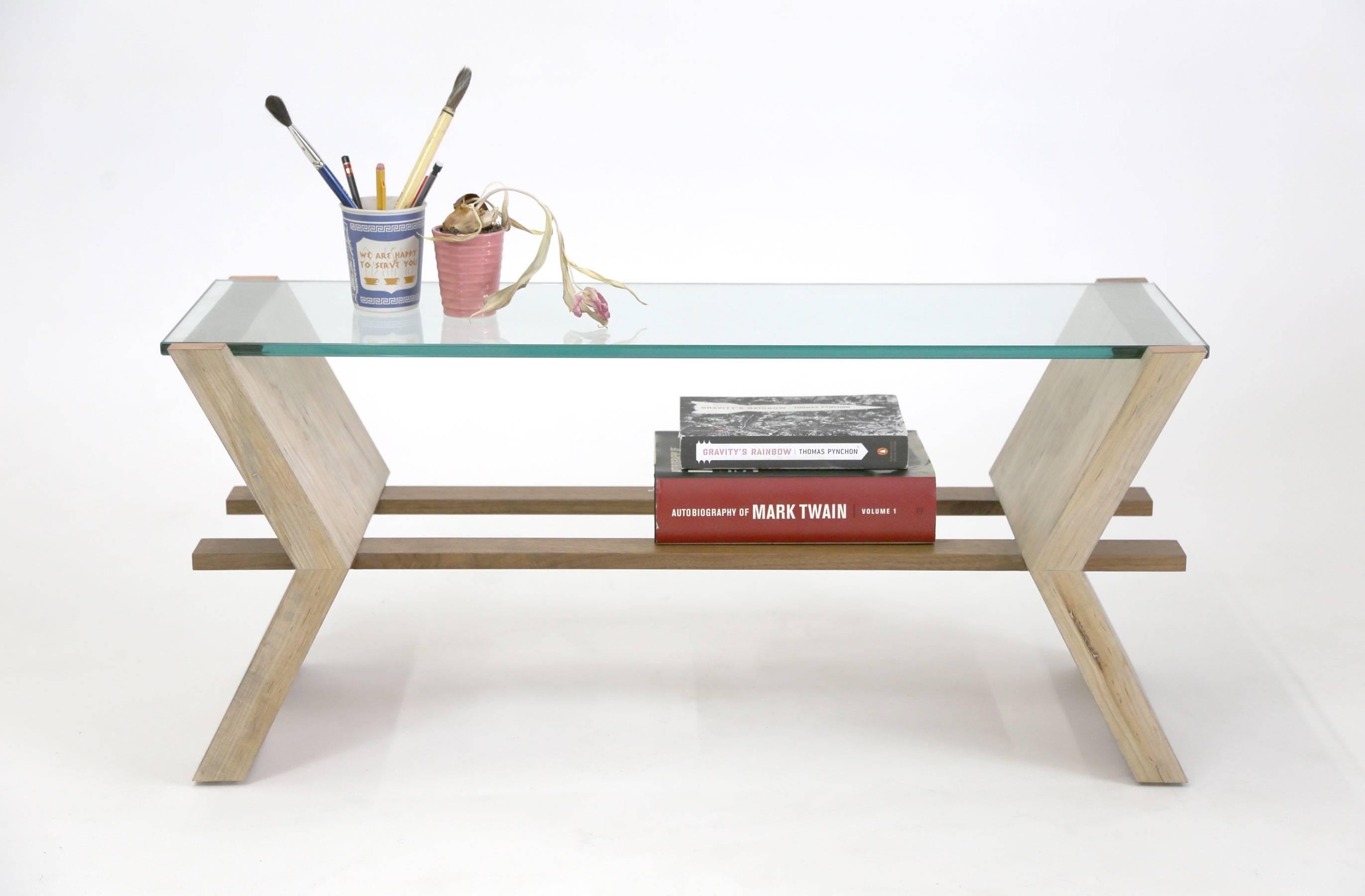 Inspired by the construction of our 'Friends' bookcase, the coffee table version features angled maple boards intersecting with parallel walnut planks creating an architectural composition with glass and just a touch of copper detail.

Each piece is