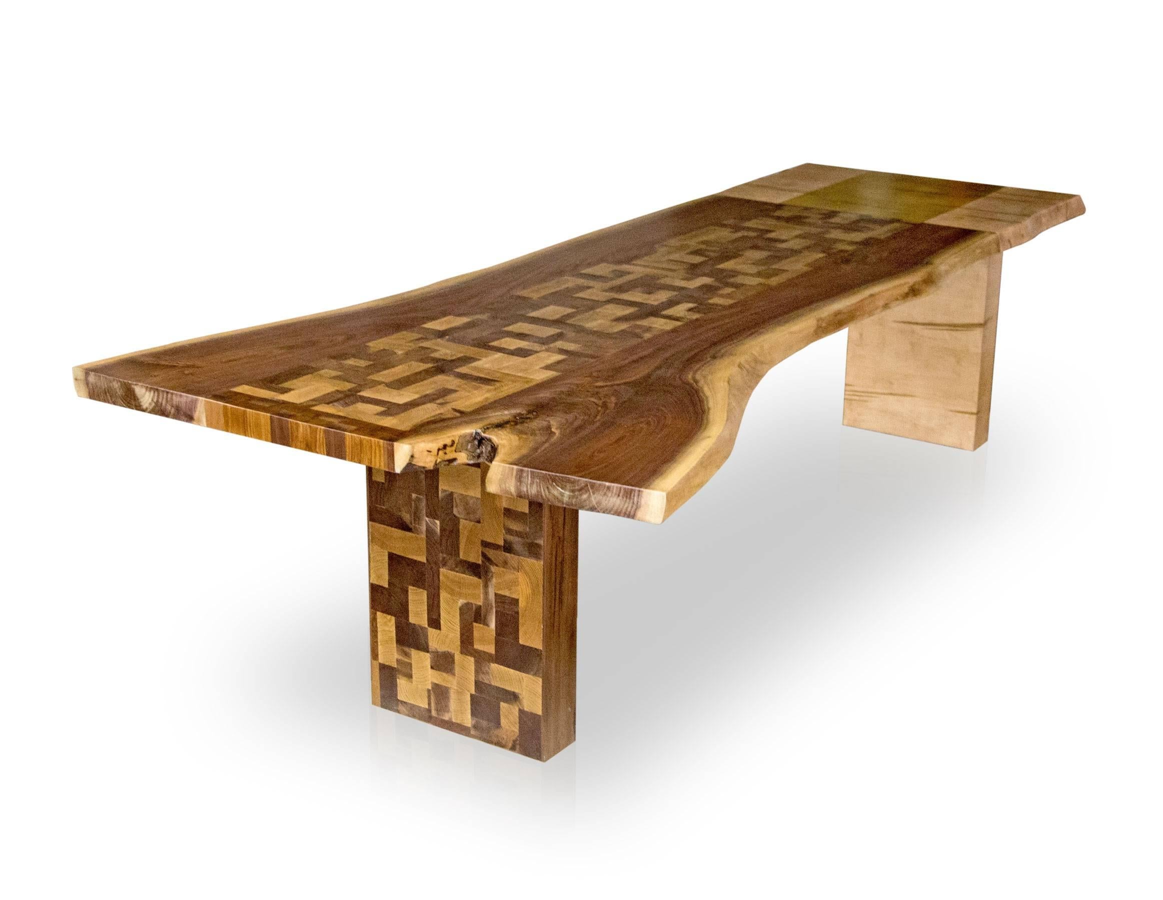 One off, one of a kind mosaic table combining walnut and maple in an artistic design. The pattern of blocked engrain walnut and gold strip down the center of the table contrasts and creates an interesting harmony between the two wood types. The