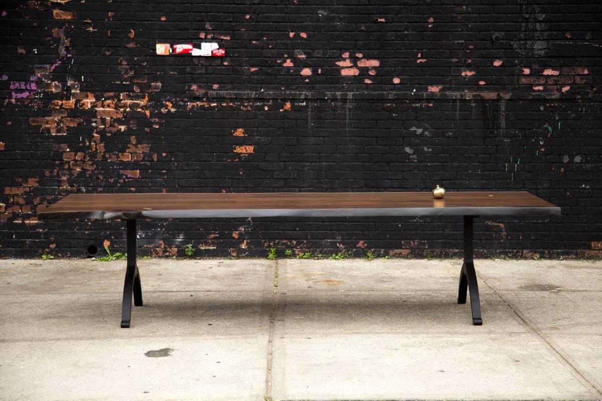 Solid American black walnut live edge tabletop paired with our blackened steel wishbone legs. Our tables let the walnut grain speak for itself with a durable clear coat finish over the wood with no stain. Our work has been featured in some of the
