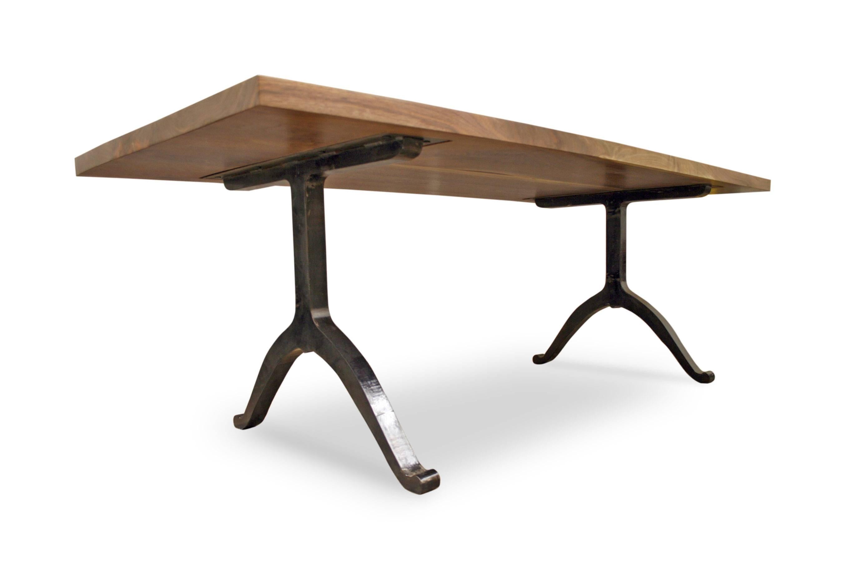 This table is constructed using local Pennsylvanian black walnut, with an almost invisible finish to show the natural color and beauty of the grain. Juxtaposed with our Wishbone steel leg system, the table has a unique statement: A harmony of two