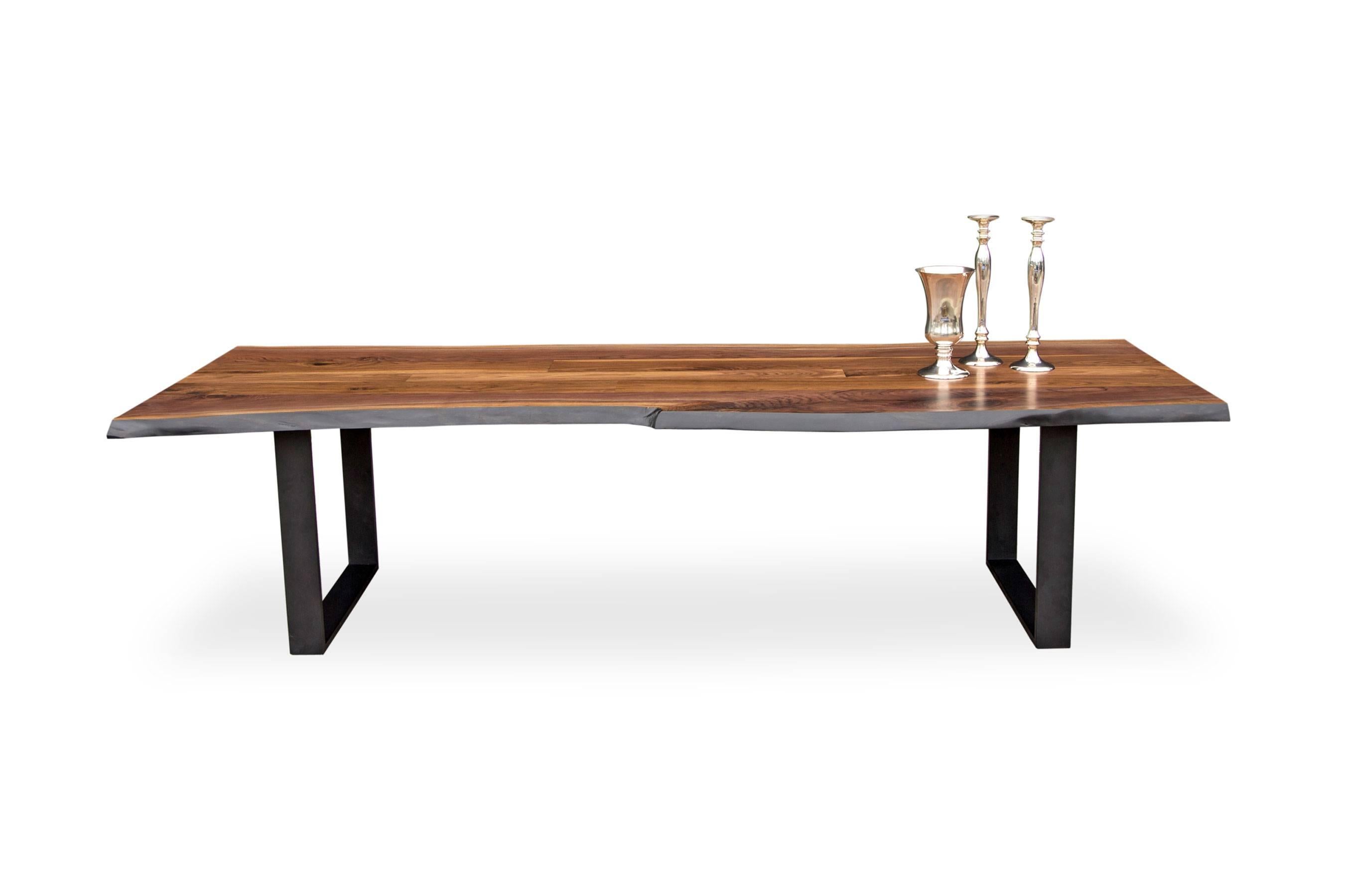 Solid American black walnut live edge tabletop paired with our solid blackened steel frame legs at 84 x 36 and 30 inches tall. 

Our tables let the walnut grain speak for itself with a durable clear coat finish over the wood and no stain. Our work