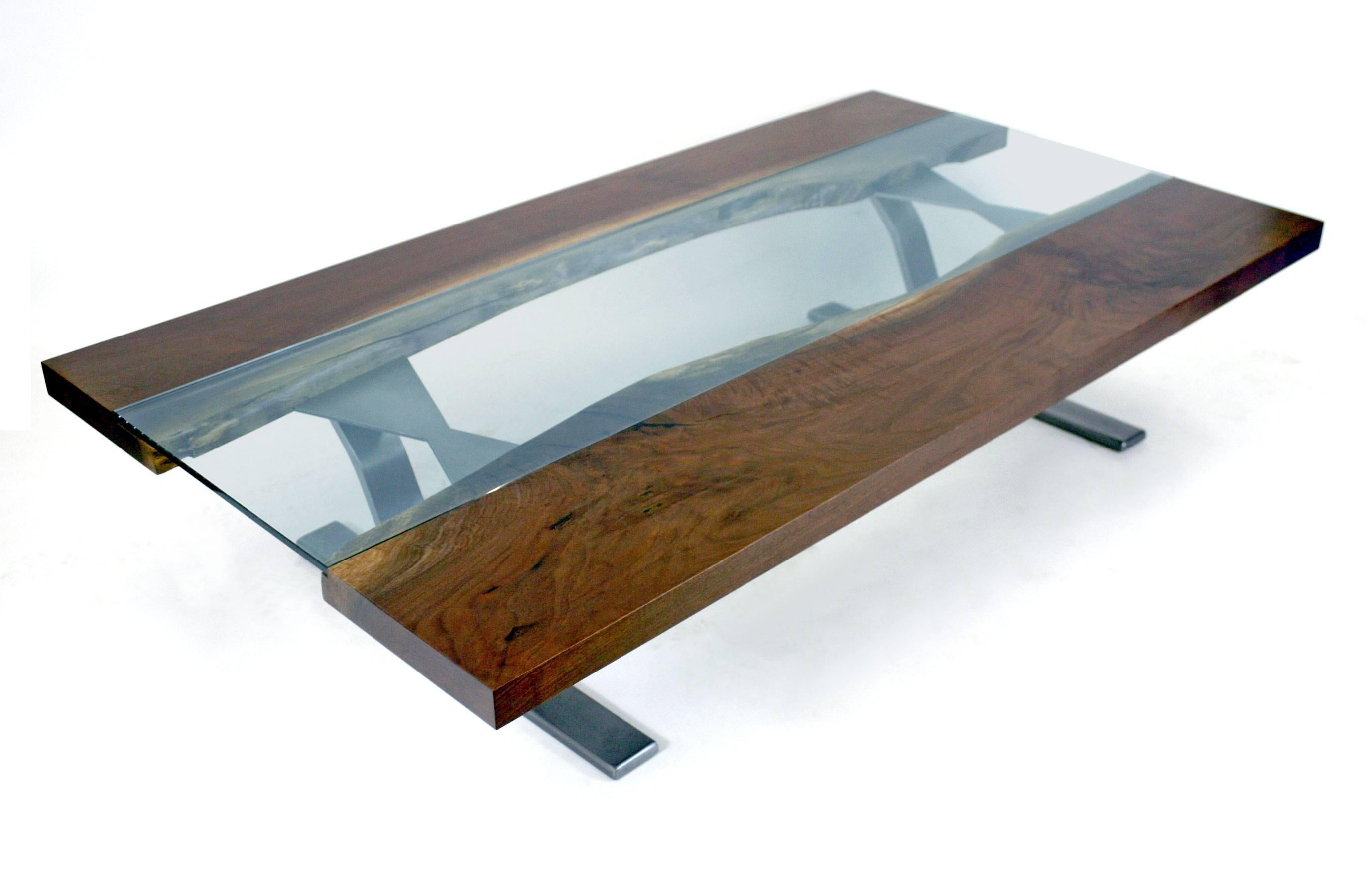 A coffee table version of one of our most sough-after designs. Features two walnut live edge boards with glass running down the center, and two natural steel finish legs. This version of the table is 60