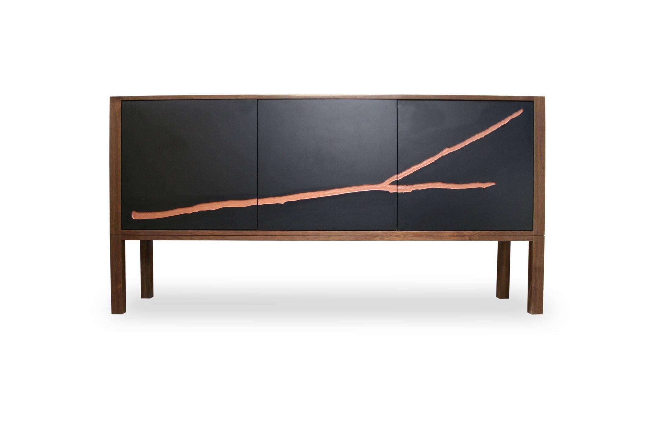 This credenza features three laser-engraved doors with inlaid artwork. The cabinet opens to store anything from stereo equipment to service ware. Inside there is adjustable shelving. The cabinet is made using locally-sourced hardwoods, including
