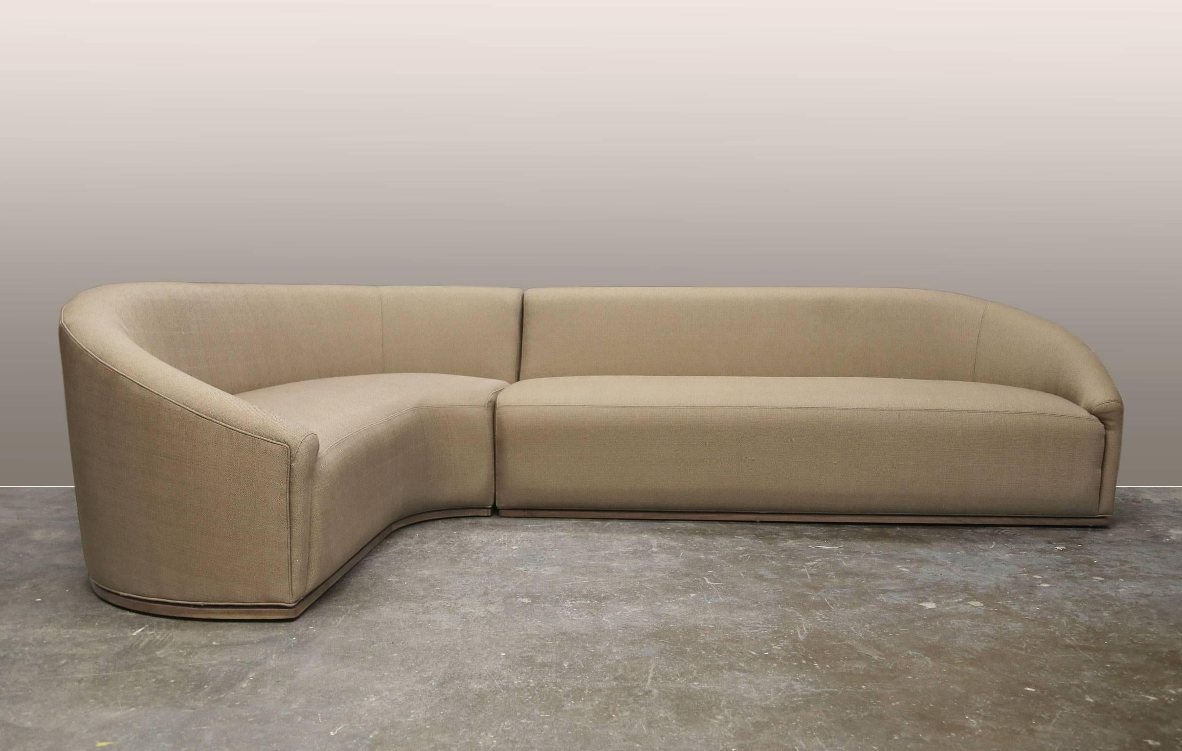 This subtle, curved sectional sofa comes in two parts. The elegant design sits upright and the soft lines evoke a seashell or a fluted wineglass. The design is a bit glam as well: it could be a welcome addition to a well appointed apartment or even