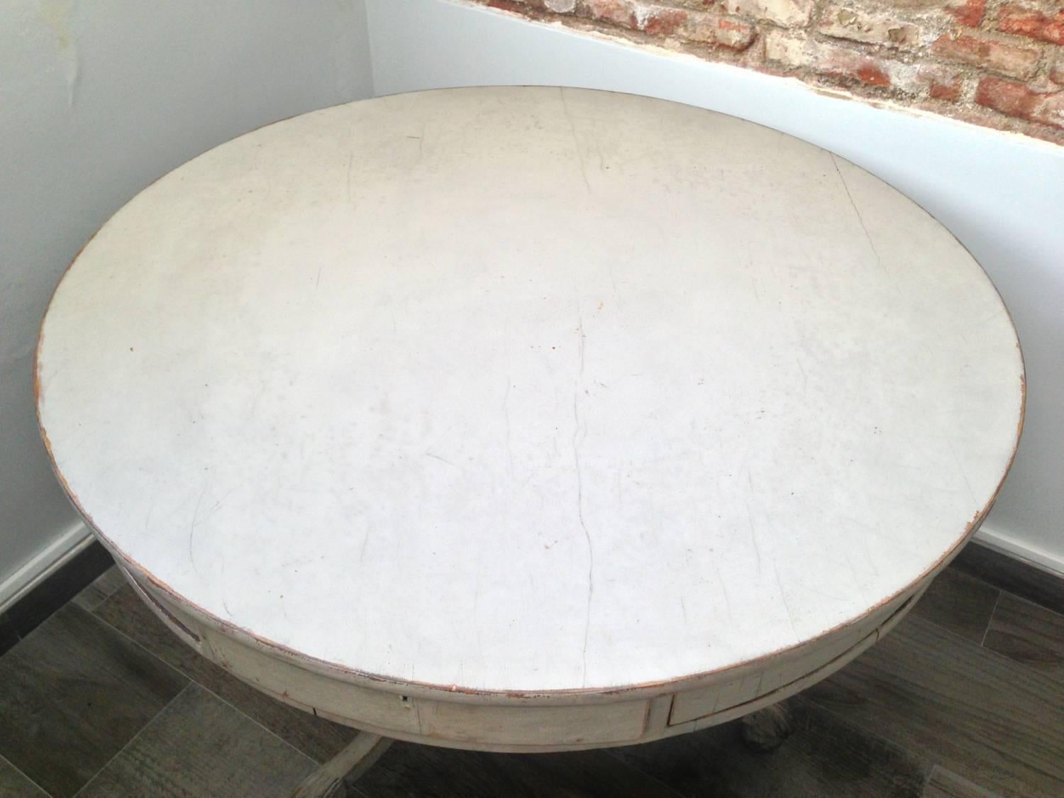 An unusual 19th century Swedish drum table with eight drawers, tripod legs and decorative carved foots.