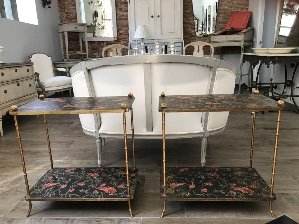 Pair of Italian side tables with faux bamboo brass legs and lacquered shelves decorated with birds and flowers. Circa 1960.