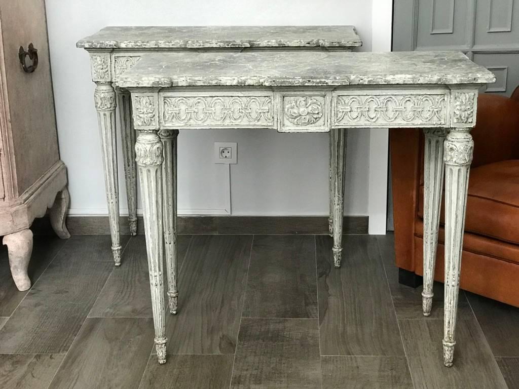 Pair of late 19th century French Louis XVI style consoles made of carved and painted wood. 