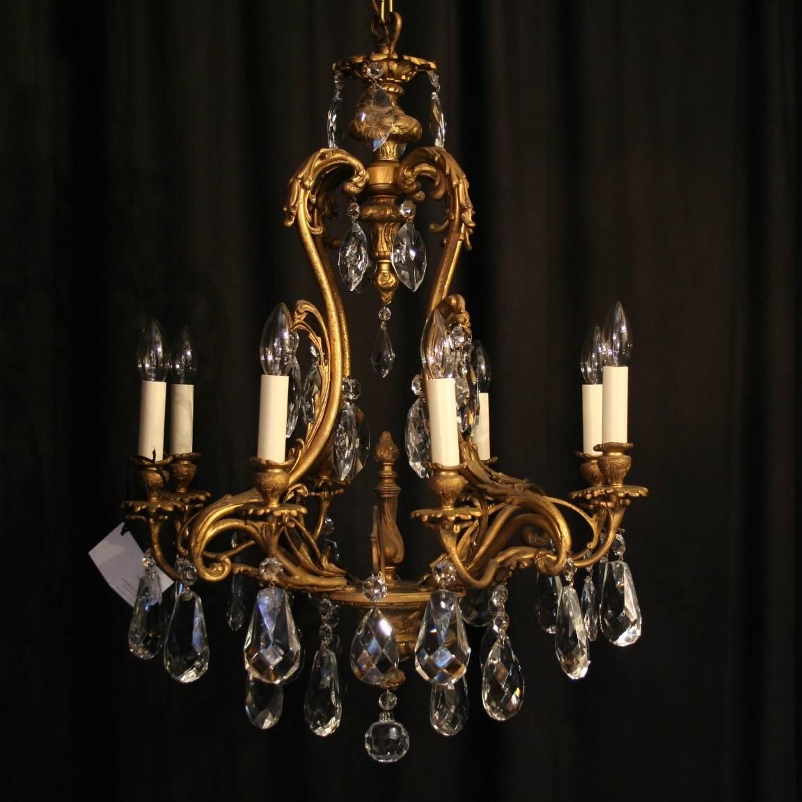 An ornate Italian gilded cast bronze and crystal eight and six-light cage form antique chandeliers, the scrolling arms with foliated leaf bobeches drip pans and leaf bulbous candle sconces, issuing from an Acanthus leaf cage form interior with a