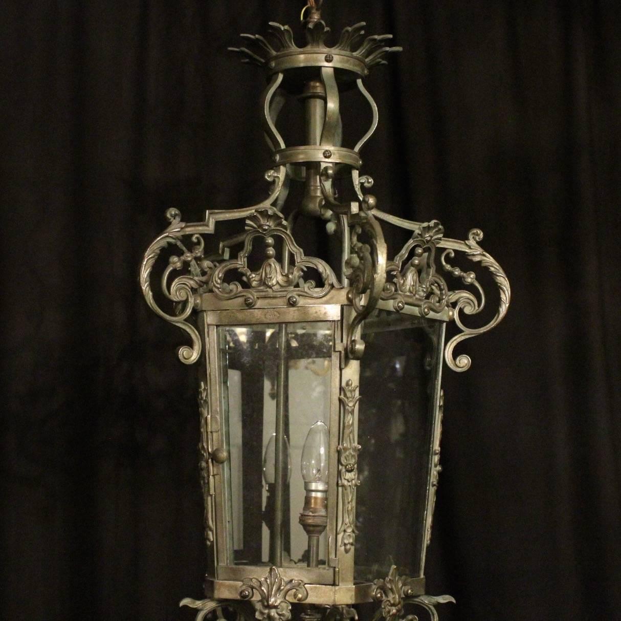 £1,350
 
A French cast bronze single light antique gasolier lantern, the single light fitting surrounded by five sectional tapering glass panels and held within an ornately cast heavy gauge scrolling framework with side reeded panels, decorative