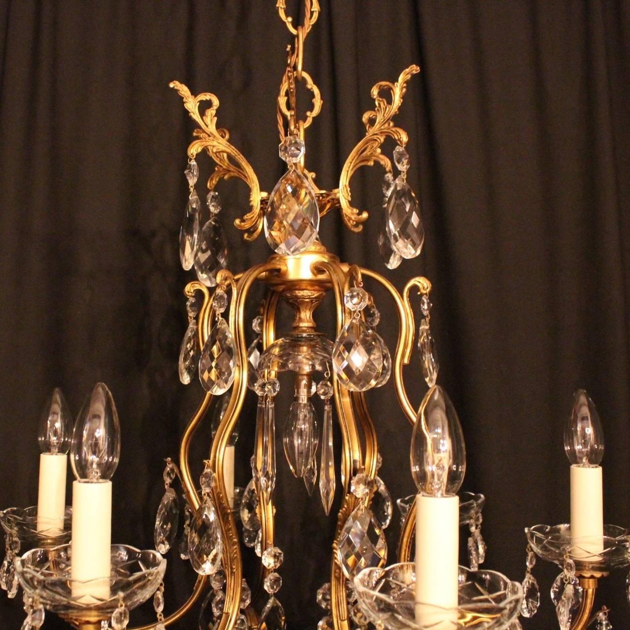 A French gilded cast brass and crystal seven-light birdcage form antique chandelier, the six acanthus leaf scrolling arms with glass bobeche drip pans, issuing from a cage form interior with a single inverted light fitting and large central