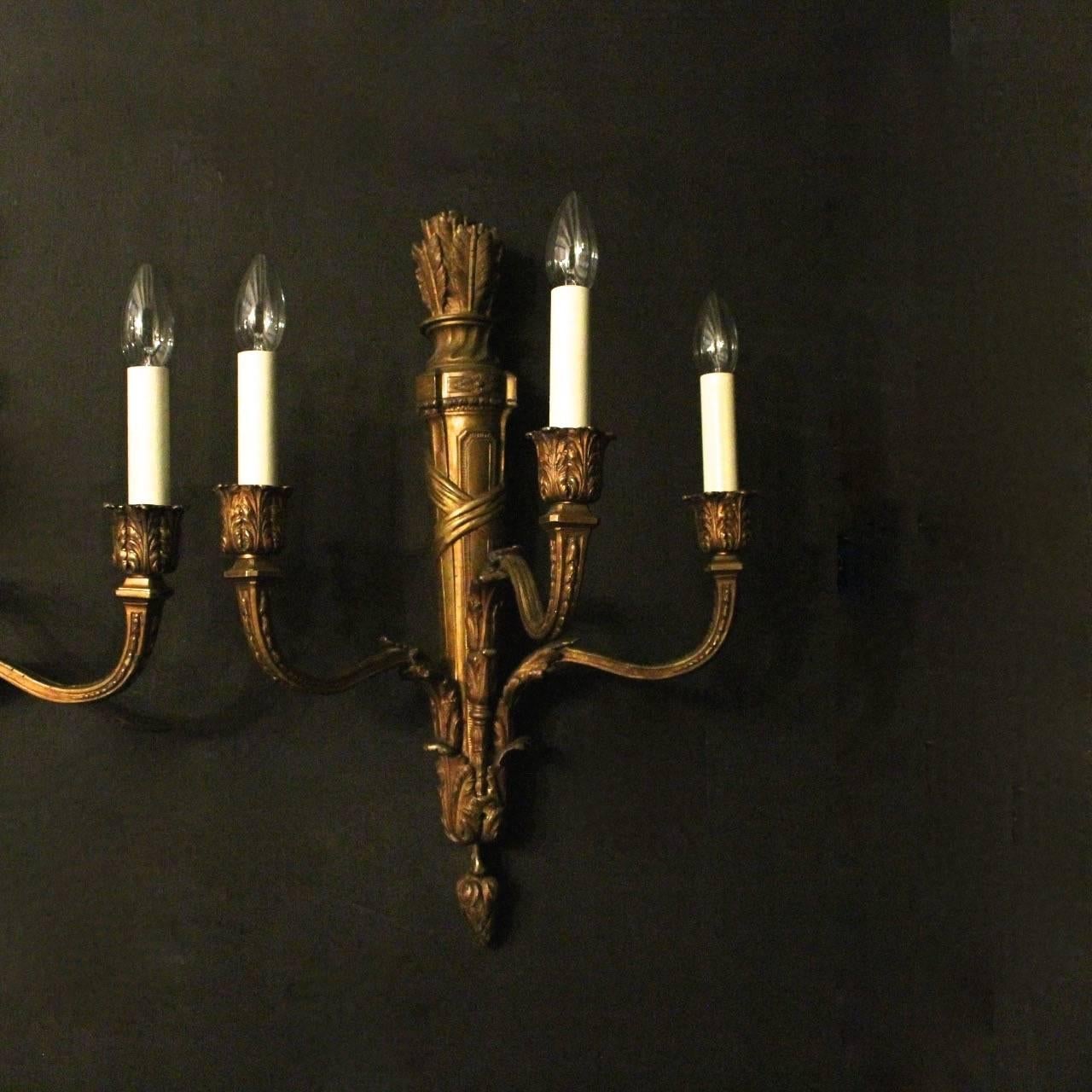 French large set of four gilded bronze triple arm antique wall lights, the tapering orante square gauge scrolling arms with decorative leaf bulbous candle sconces, issuing from a decoratively cast elongated quiver backplate with arrow headed finial