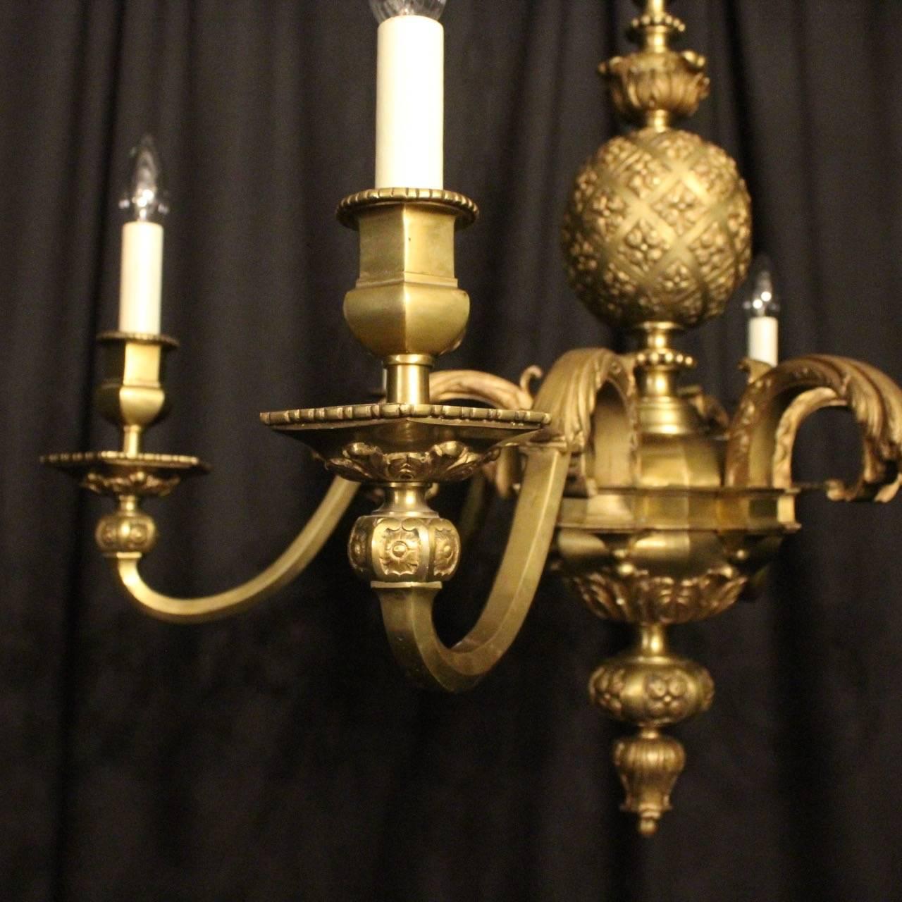 A large French gilded bronze six-light Gothic inspired antique chandelier, the ornately cast scrolling arms with sectional bobeche drip pans and bulbous sectional candle sconces, issuing from a decorative central sectional column with etched bulbous