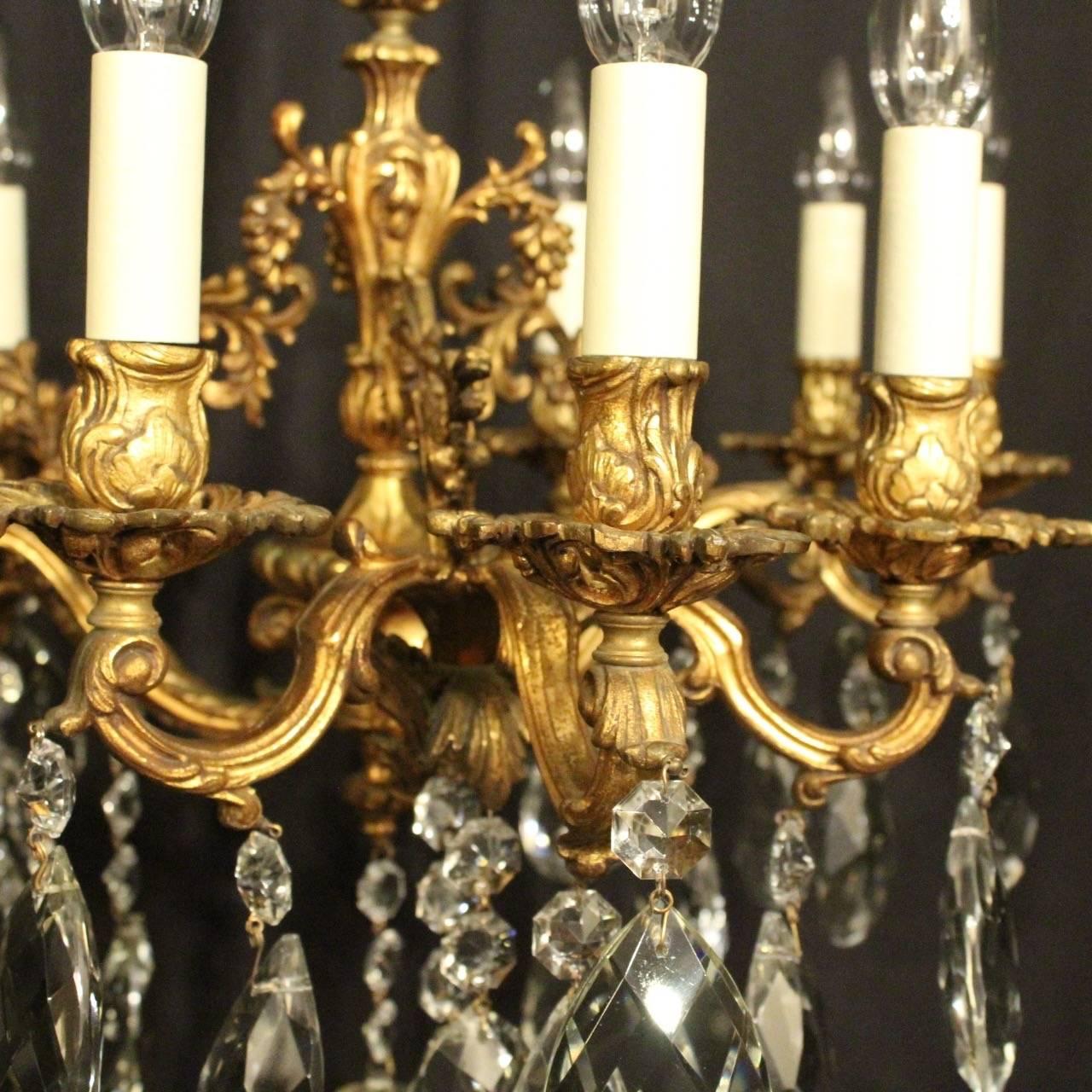 An ornate Italian gilded cast bronze 9 light antique chandelier, the foliated leaf scrolling arms with sectional leaf pierced bobeche drip pans and bulbous candle sconces, issuing from an ornately cast central leaf clad column and decorated overall