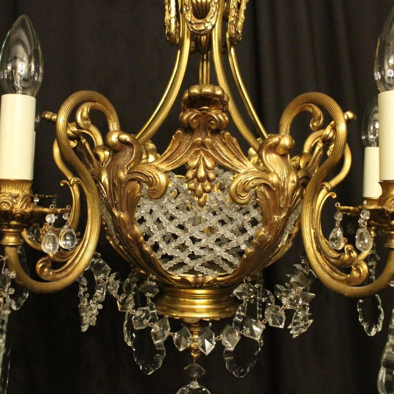 A French gilded bronze and crystal six-light birdcage form antique chandelier, the five ornate leaf and reeded scrolling arms with foliated bobeche drip pans and bulbous candle sconces, issuing from a cage form interior decorated with lovely cut