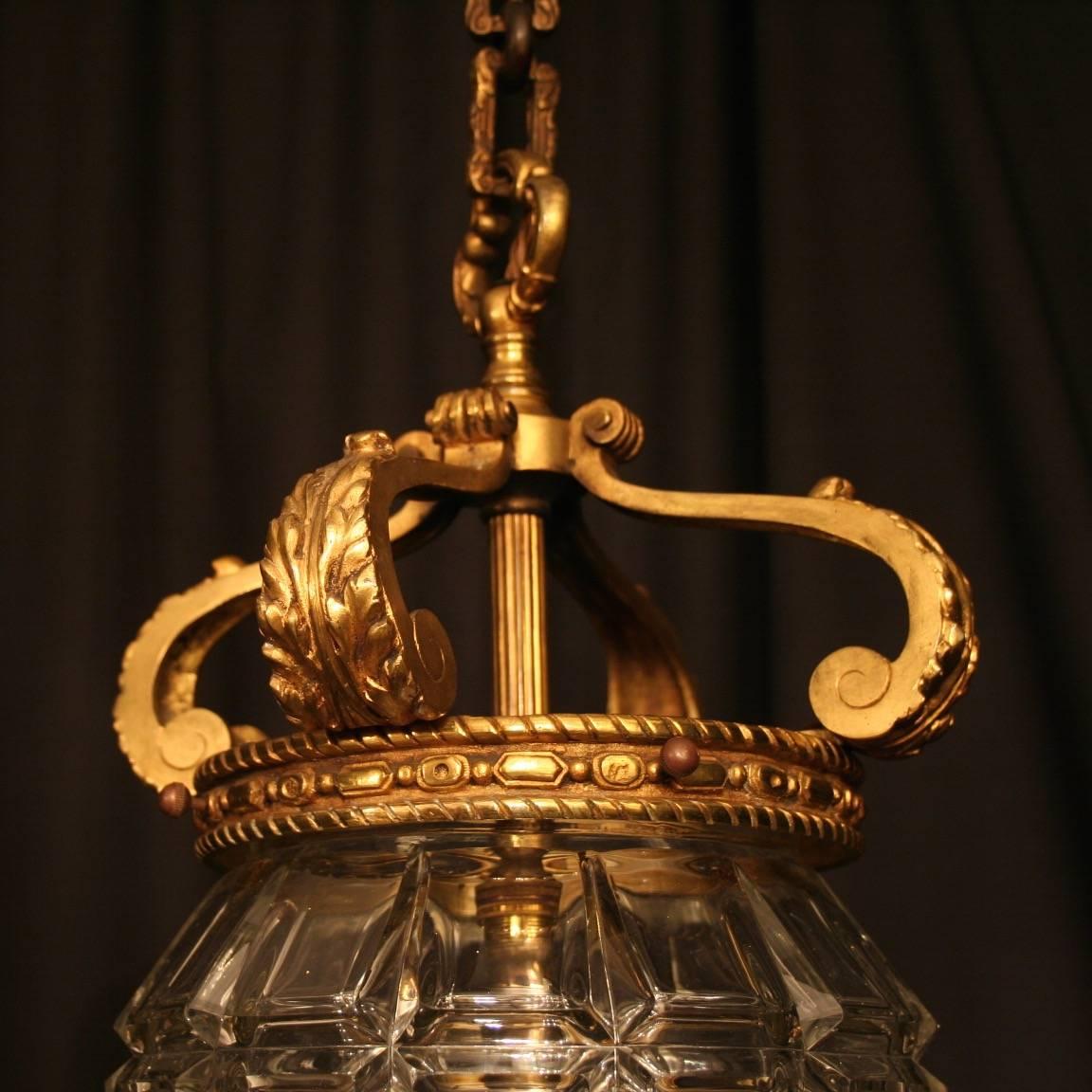 A French gilded cast bronze single light antique hall lantern, the inverted light fittings surrounded by a single lozenge cut-glass bowl and held within a very ornately cast bronze scrolling framework with lovely open top acanthus leaf canopy and
