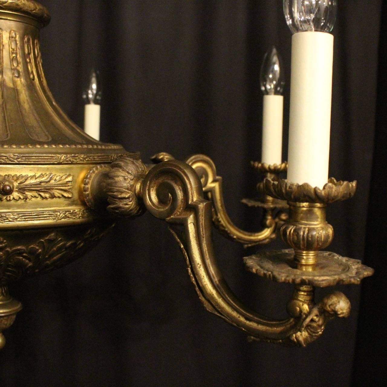 A quality French gilded bronze six-light antique chandelier, the ornately cast winged cherub clad scrolling arms with leaf bobeche drip pans and bulbous reeded candle sconces, issuing from a reeded tapering central column with Acanthus leaf finial