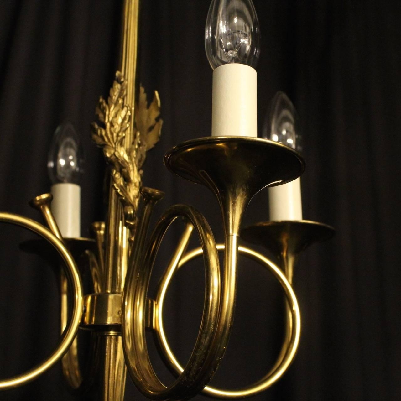 A French gilded cast brass four-arm Maison Bagues chandelier, the scrolling trumpet bobeche drip pans, issuing from a decoratively cast elongated rope and tassel central column, nicely cast and good crisp patination. Fully rewired and PAT tested.
 