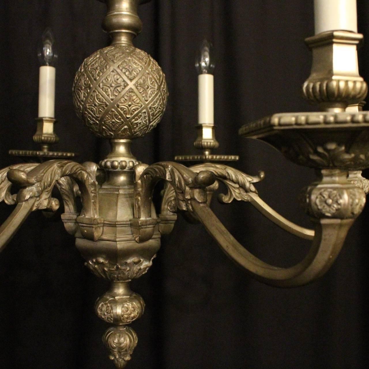 A French silver gilded burnished bronze six-light Gothic antique chandelier, the ornately cast scrolling arms with sectional bobeche drip pans and bulbous sectional candle sconces, issuing from a decorative central column with etched bulbous centre