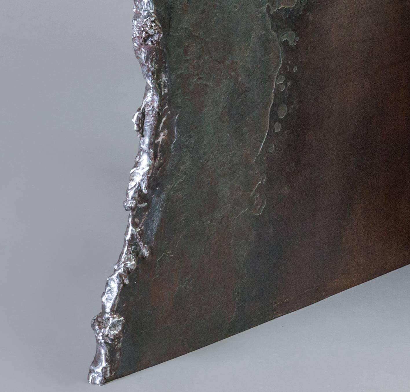 Contemporary / minimal bisecting steel plates. Melted edge steel base. 
One of a kind. ¾” thick steel. Japanese brown patina with oil and wax finish.

Dimensions: 17” H base: 24” x 36” glass top: 29” x 42” x ¾” thick.