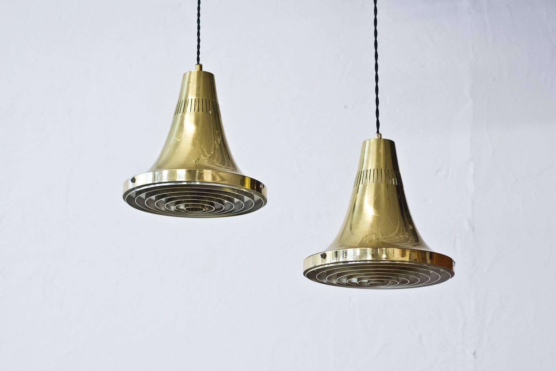 Mid-Century ceiling lights designed by Hans-Agne Jakobsson. Produced by his own company in Sweden during the 1960s. Polished brass with white lacquered inside and original chromed plastic diffuser. New fabric electric chord. Very good condition,