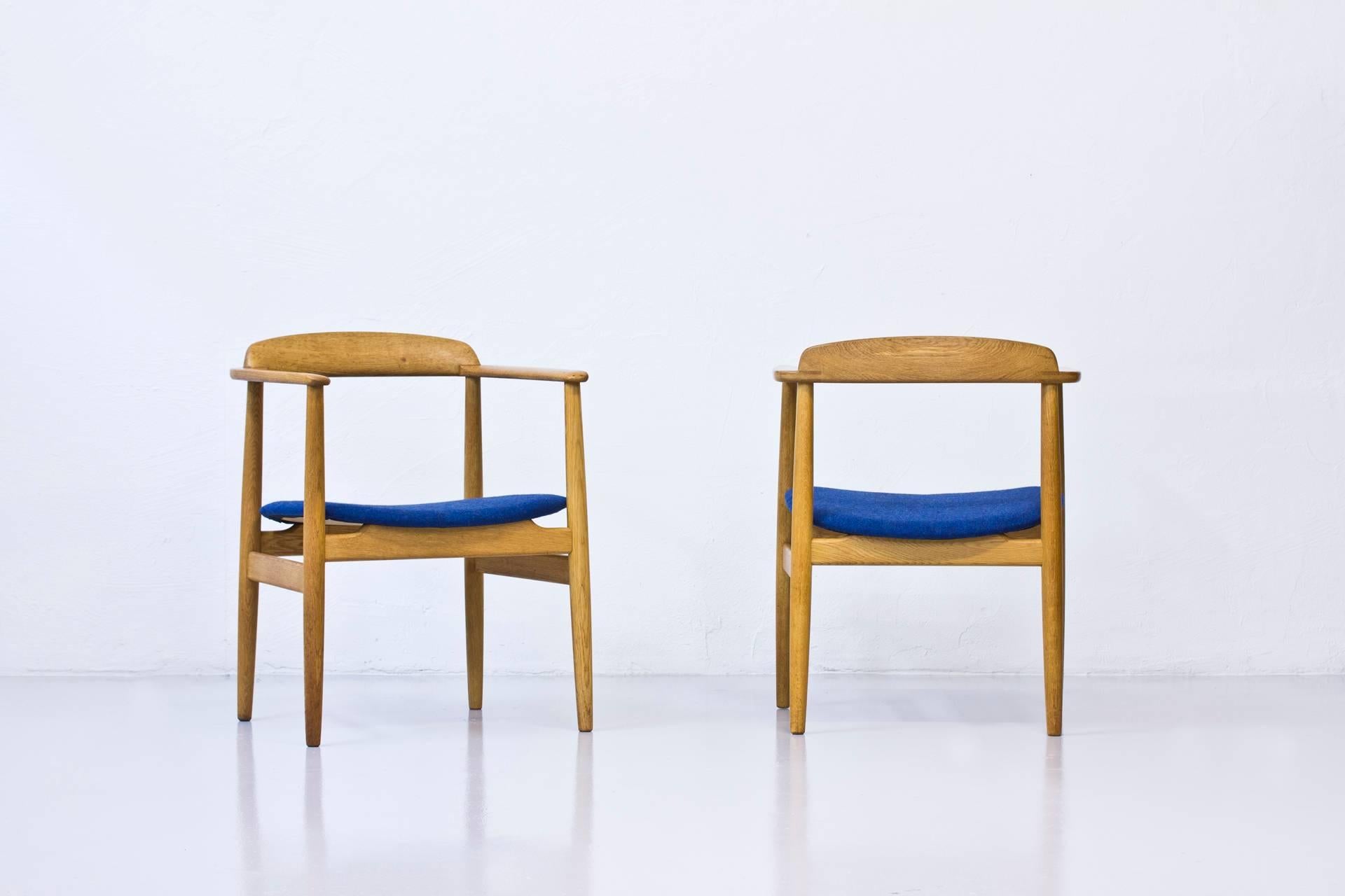 Rare armchairs designed by Alf Svensson during the early 1960s. Produced by his own company Bjästa Möbelfabrik in Sweden. This pair produced in 1961. (Signed). Solid oak frame in very good condition with minor scratches and marks consistent with