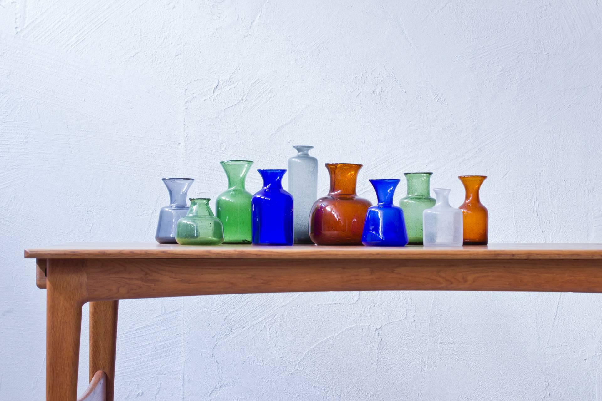 Collection of ten vases designed by Erik Hoglund. Handblown at Boda glass hut during the 1950s. Ten different sizes, colors and shapes in very good to excellent condition. All pieces signed on the bottom.
     