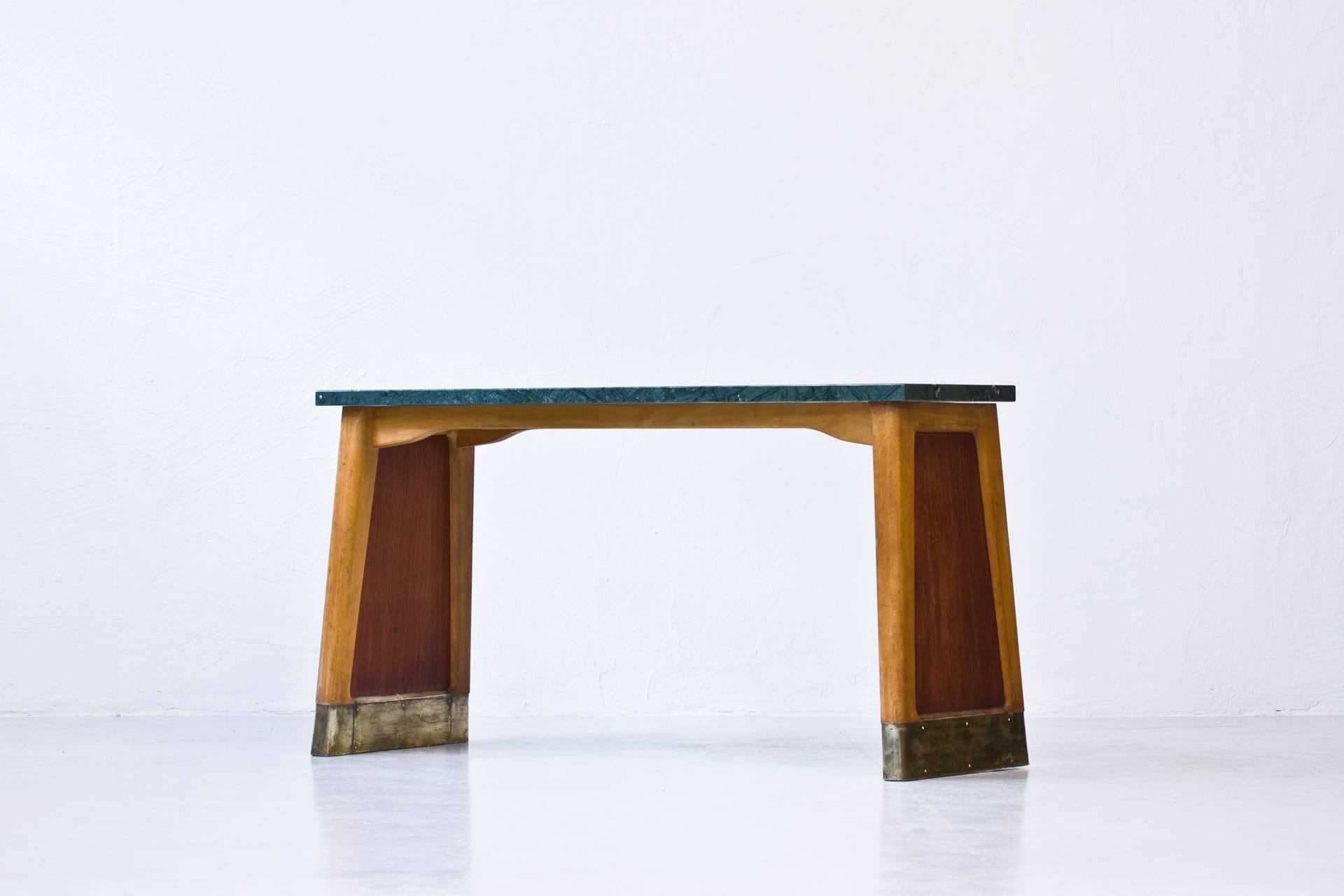 Console table with thick green marble tabletop. Solid beech and teak frame with handmade brass endings. Most likely produced by Bodafors in Sweden and designed by David Rosén during the 1940s. Very good original condition.
 