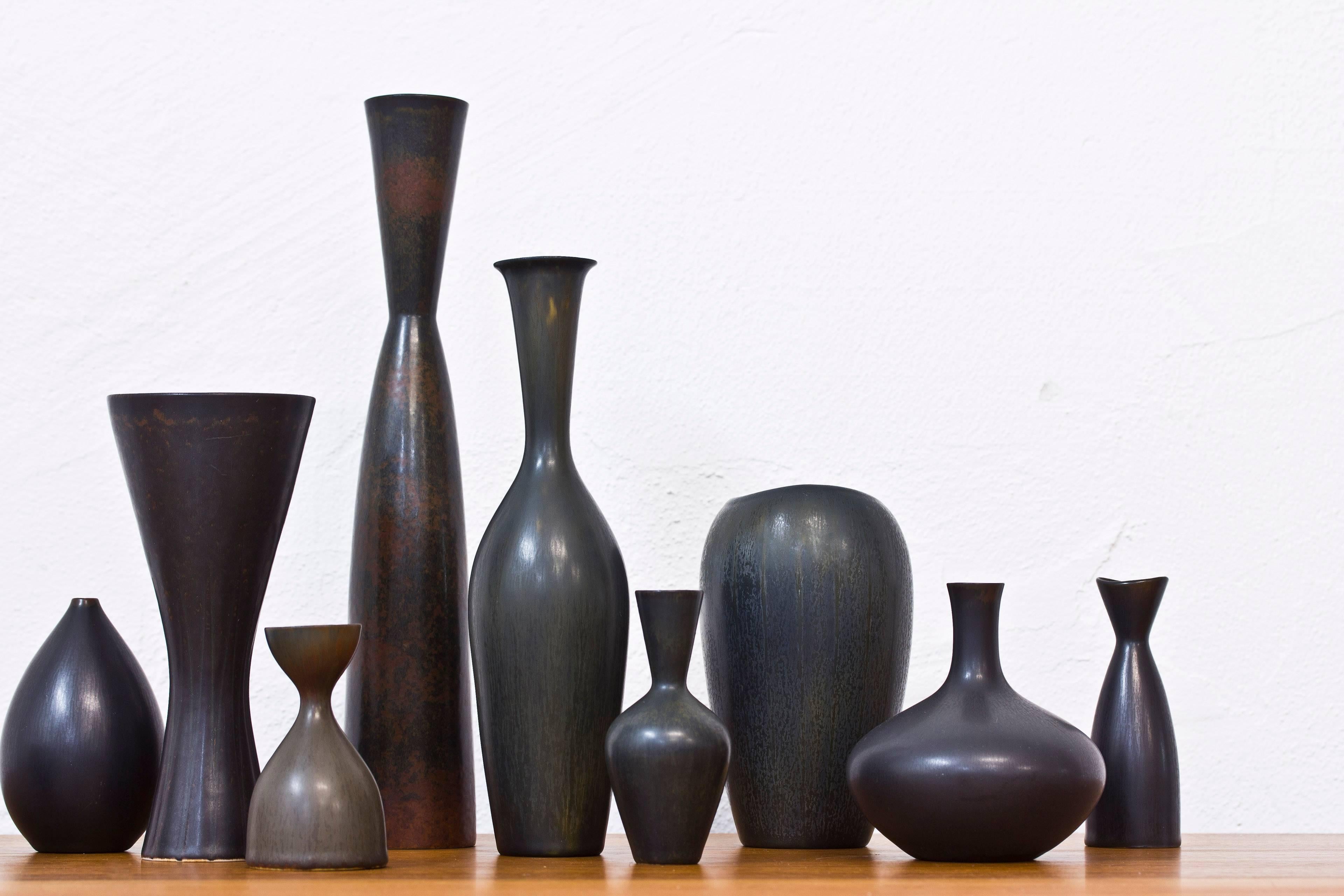 Collection of ten stoneware vases designed by Carl Harry Stalhane and Gunnar Nylund. Hand made at Rorstrand in Sweden during the 1950s-1960s. Shifting black glazes some with relief patterns. The ten vases are sold together as a collection. All
