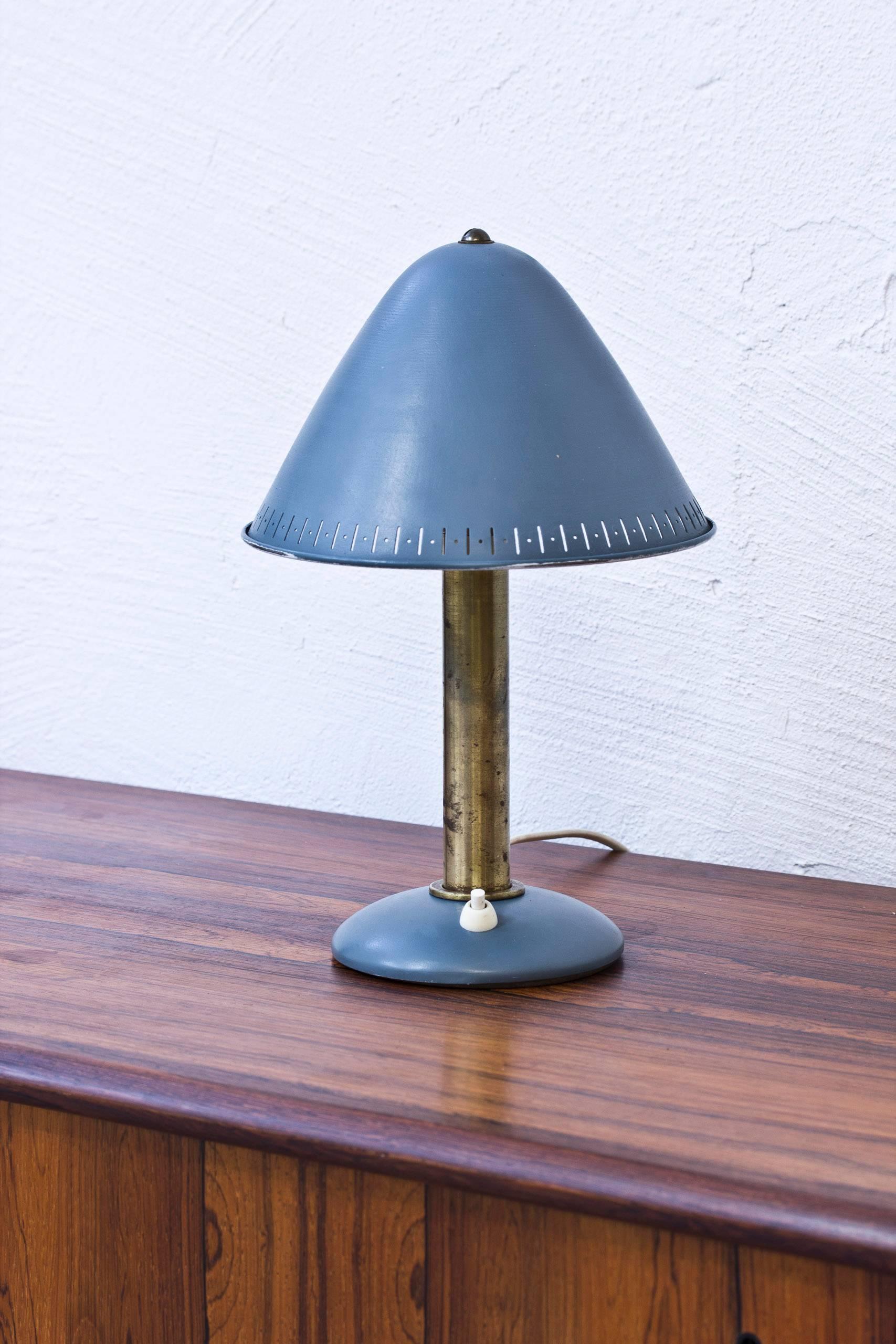 Table or wall lamp produced in Sweden by ASEA. Brass and blue lacquered metal. Adjustable shade. Light switch on the base in working order. Very good condition with age related wear and patina.
 