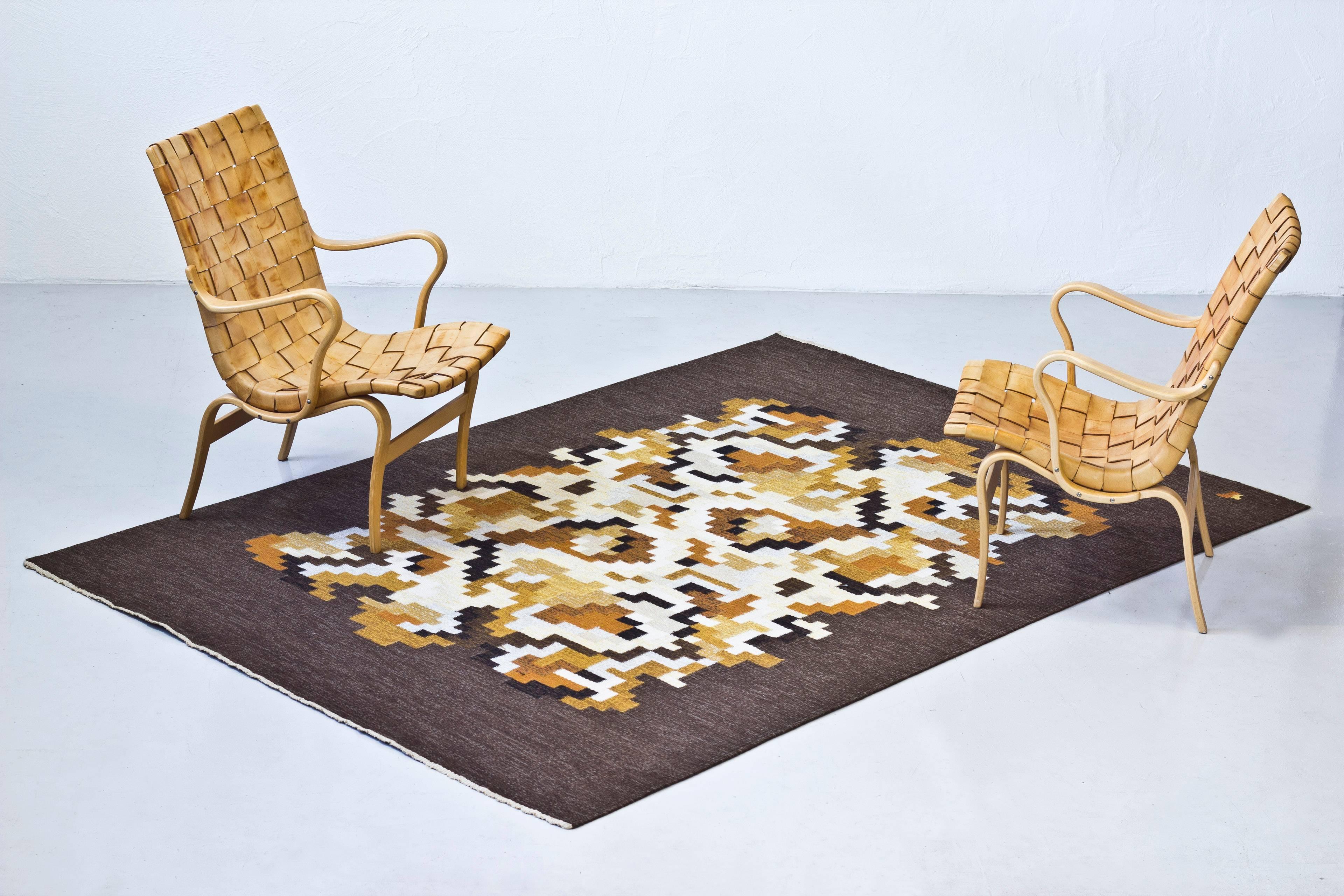 Flat-weave rug model Korall designed by Erik Lundberg. Hand made at Vavaregarden, Sweden during the 1960s. Asymmetrical pattern weaved in wool shifting in brown, yellow, orange, white and black tones. Signed with the Lundberg monogram. Very good