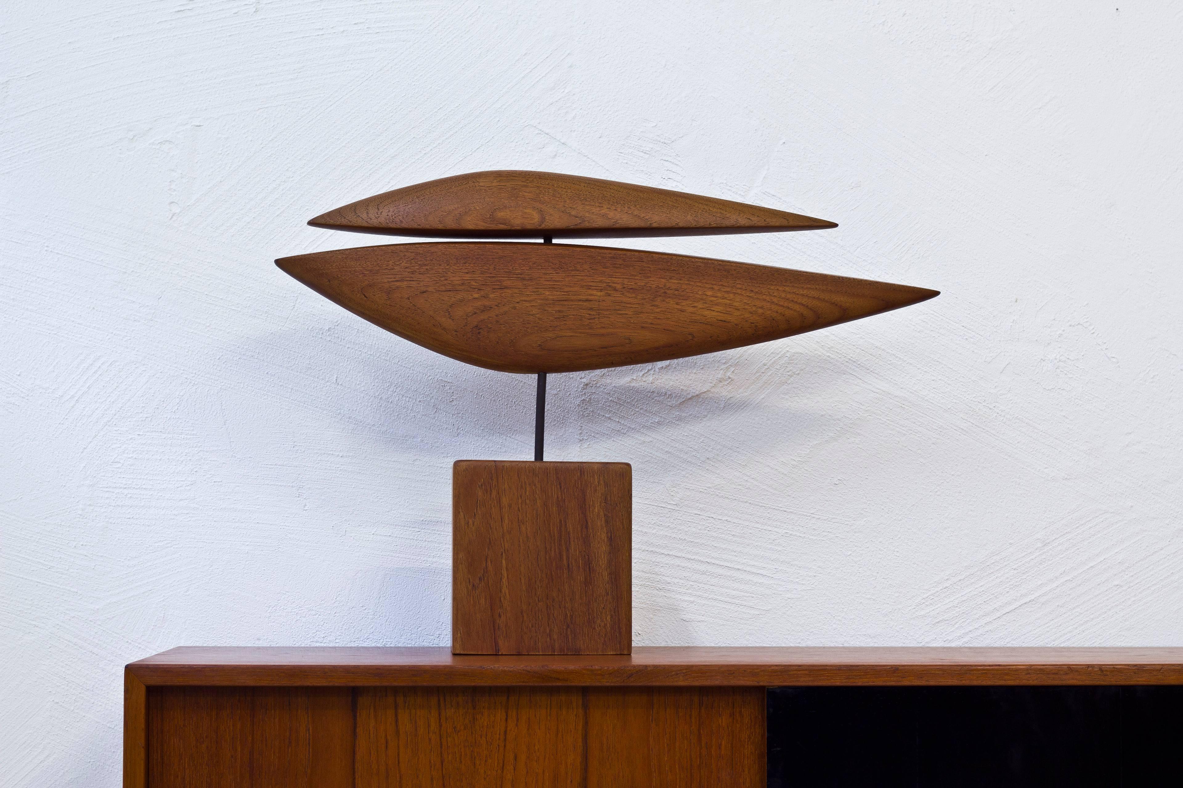 Abstract sculpture made in the 1950s by unknown Danish artist. Hand-sculpted from solid teak on an iron stem. The teak base with carved monogram signature. Excellent vintage condition with very few signs of wear and age.
 