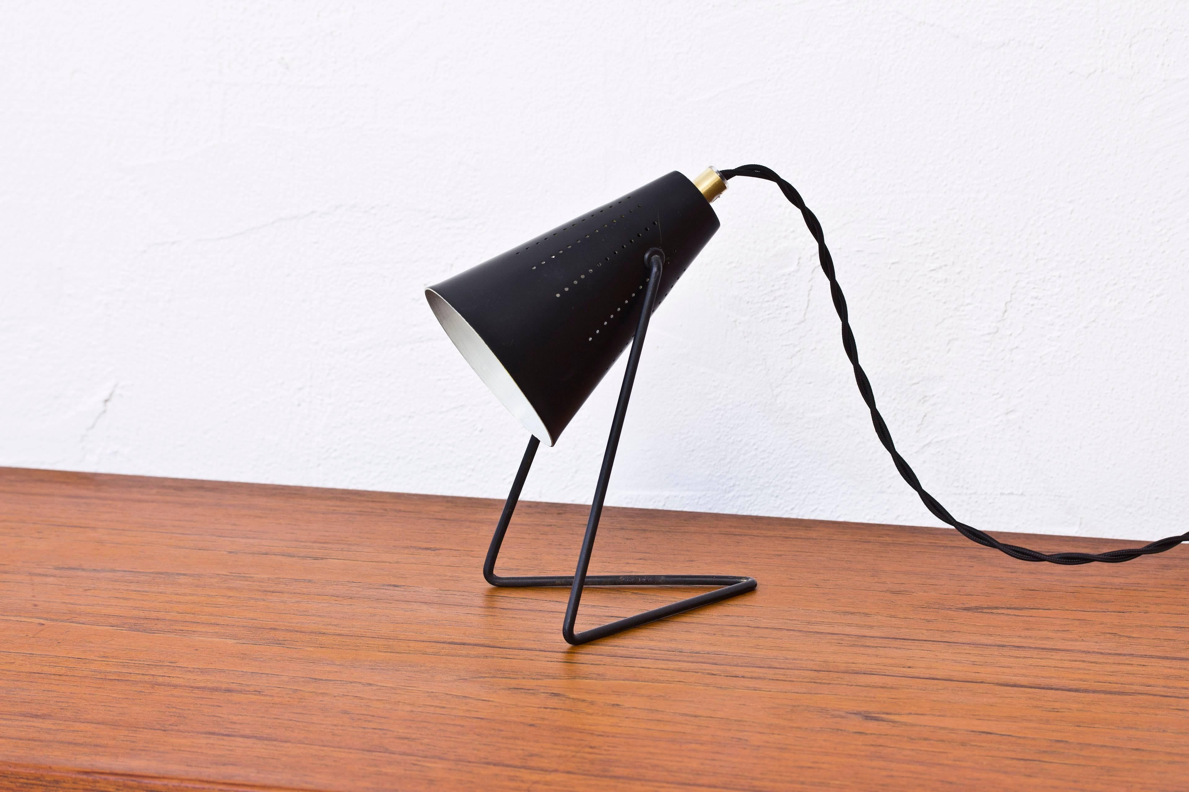 Table or wall lamp attributed to Sven Aage Holm Sørensen. Produced by ASEA in Sweden during the 1950s. Black lacquered with white lacquered inside with brass details. Very good condition with light wear and patina.