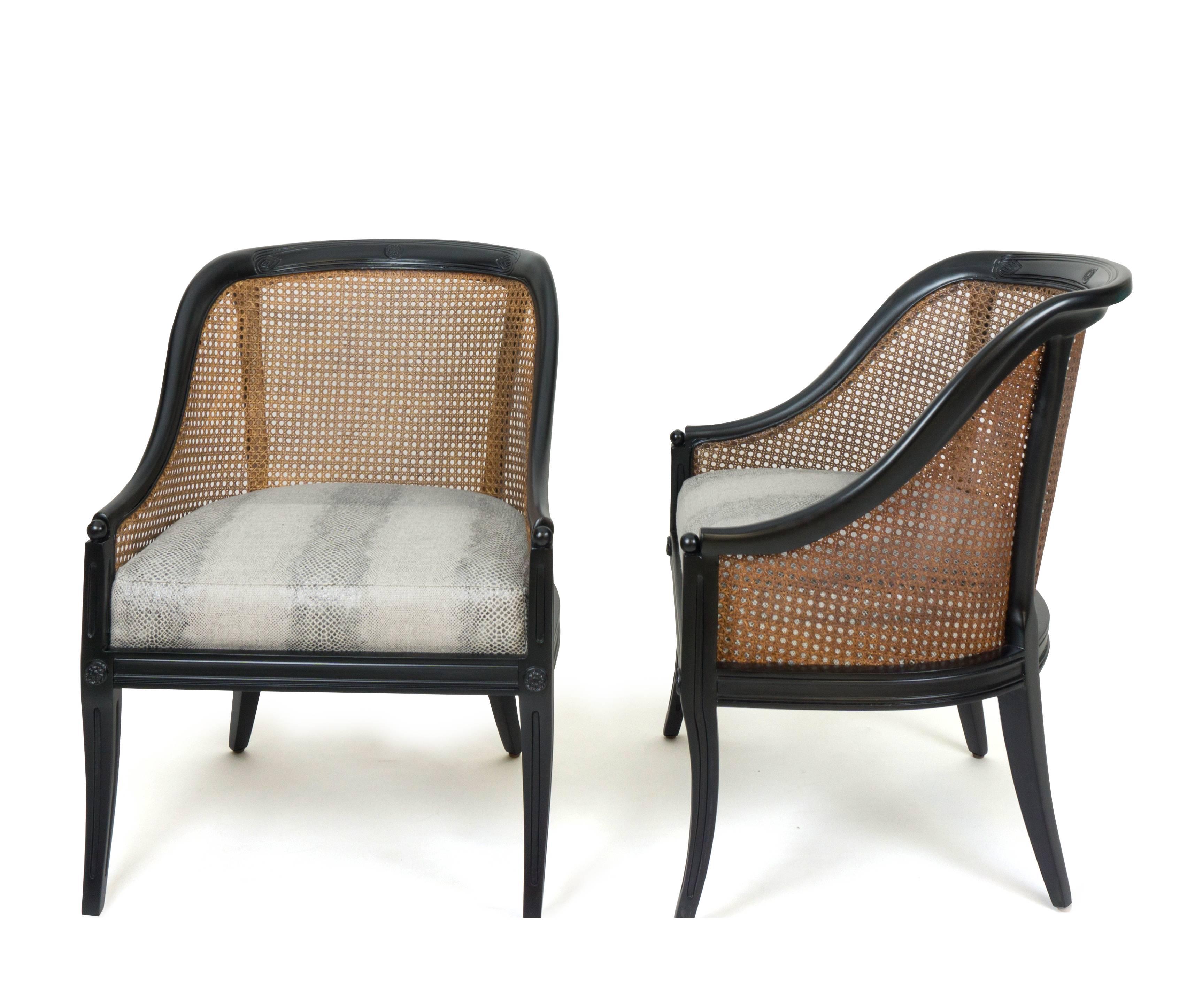 A pair of Caned Regency Gondola chairs. Frame newly lacquered by The Tailored Home in ebony. Caning stained in a honey color and is in great shape. Frame features hand carved designs. Seat newly built and upholstered by The Tailored Home in a faux