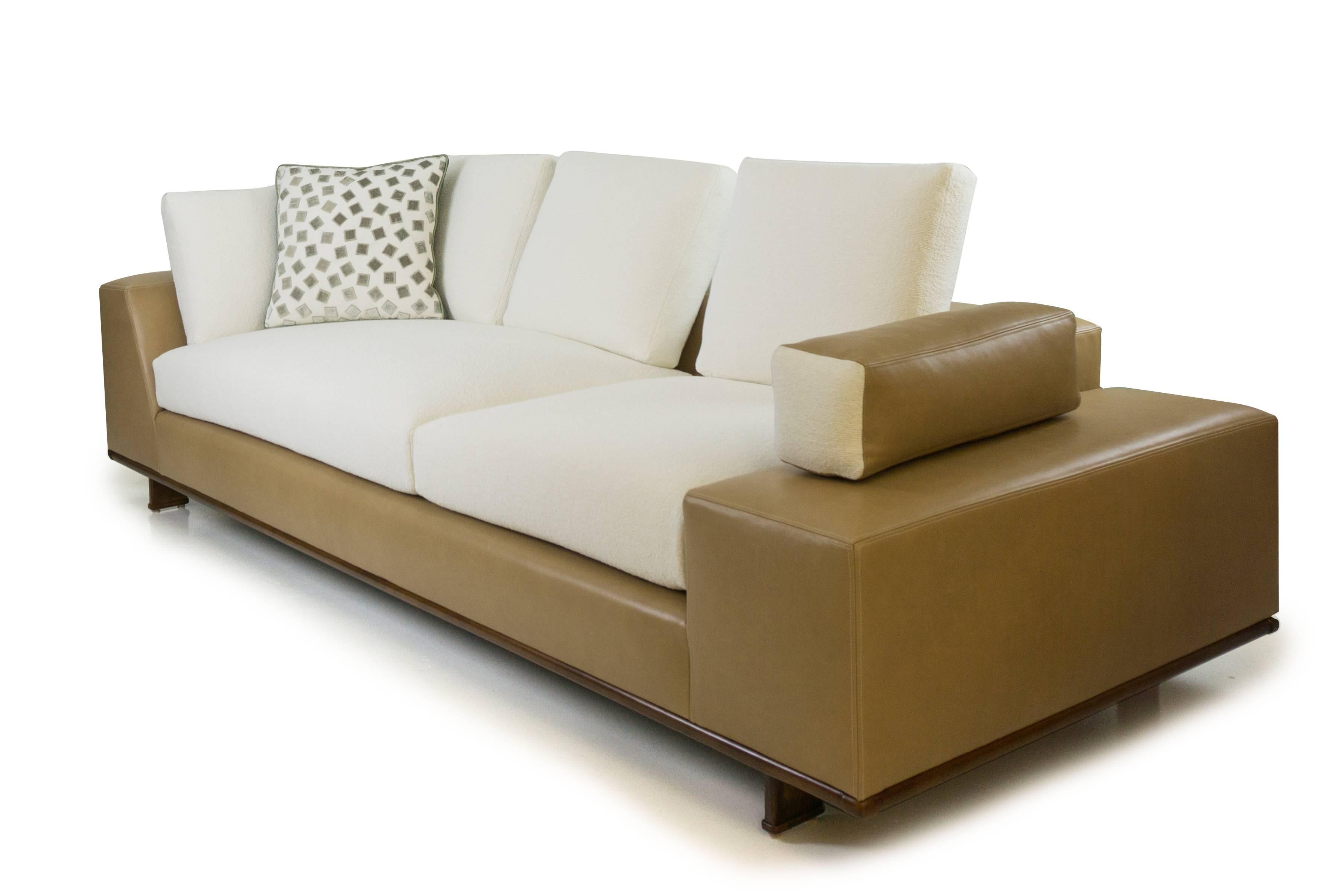 Inspired by Italian design, this contemporary sofa features a leather frame, nubby cotton cushions and an elegant wood trim. Loose back cushions keep the aesthetic airy and the asymmetrical seat cushion design is both beautiful and functional,