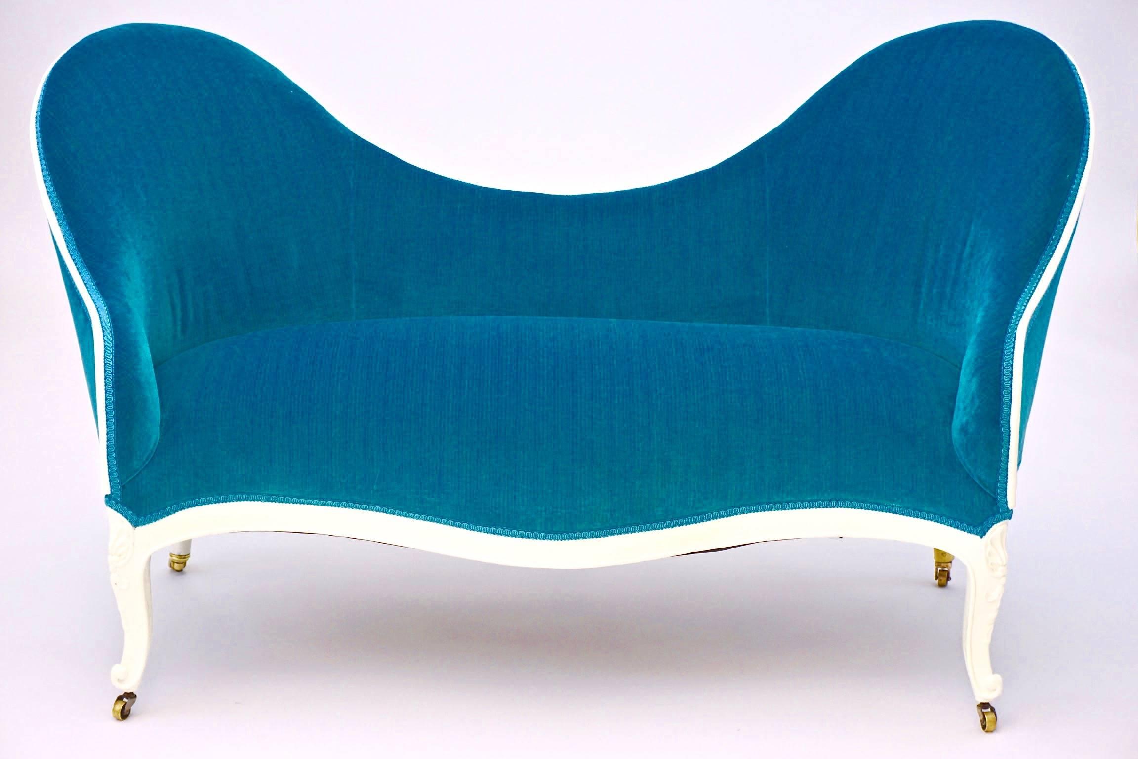 Petit Victorian Settee newly upholstered in turquoise stria velvet. White painted frame.

