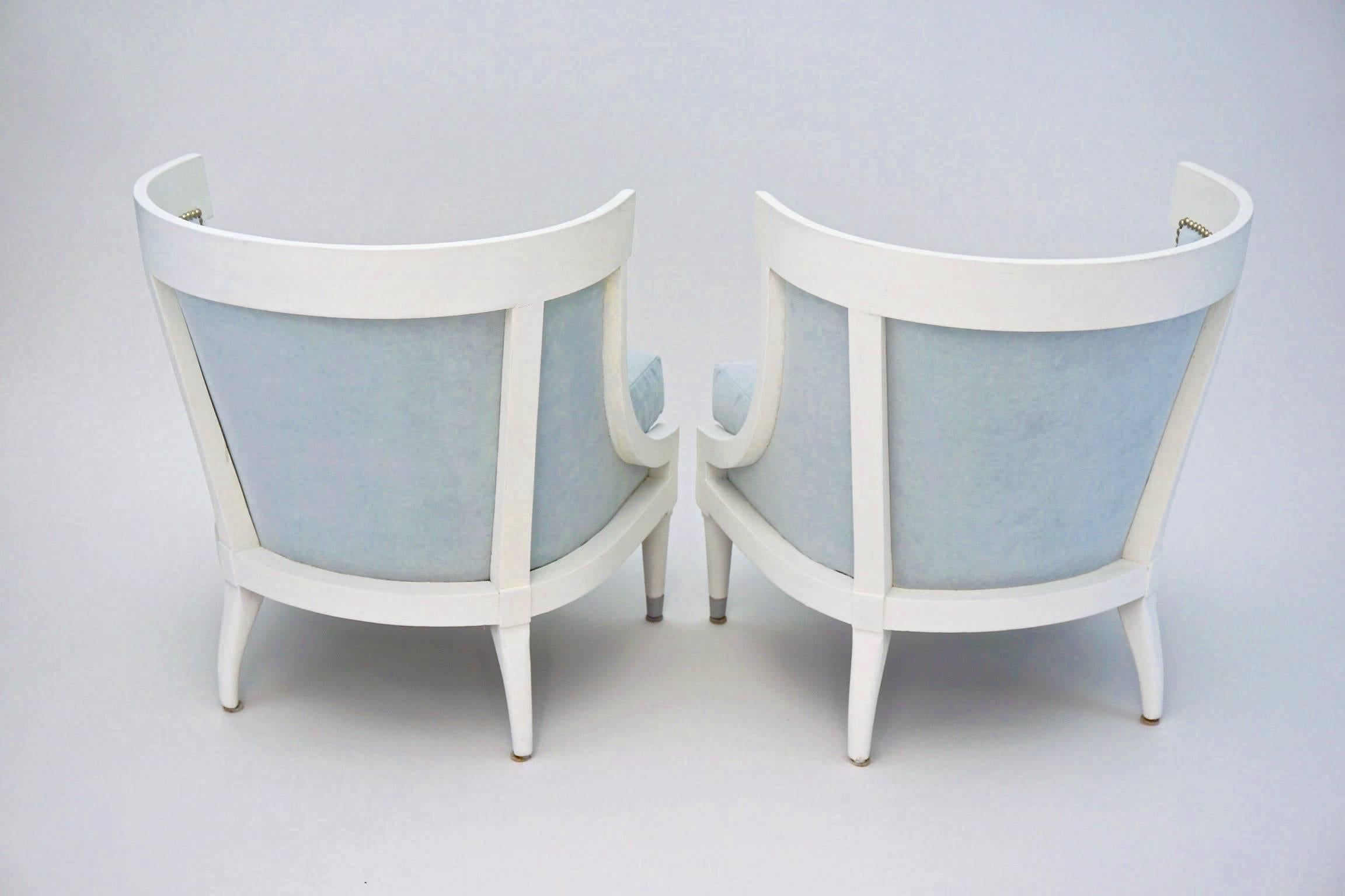 Pair of Hollywood Regency barrel-back chairs, newly upholstered in pale blue velvet punctuated with polished nickel nail heads.  Newly painted white.  Seat Cushion interiors (new) of down/feather wrap over foam core.

20% OFF listed prices on all