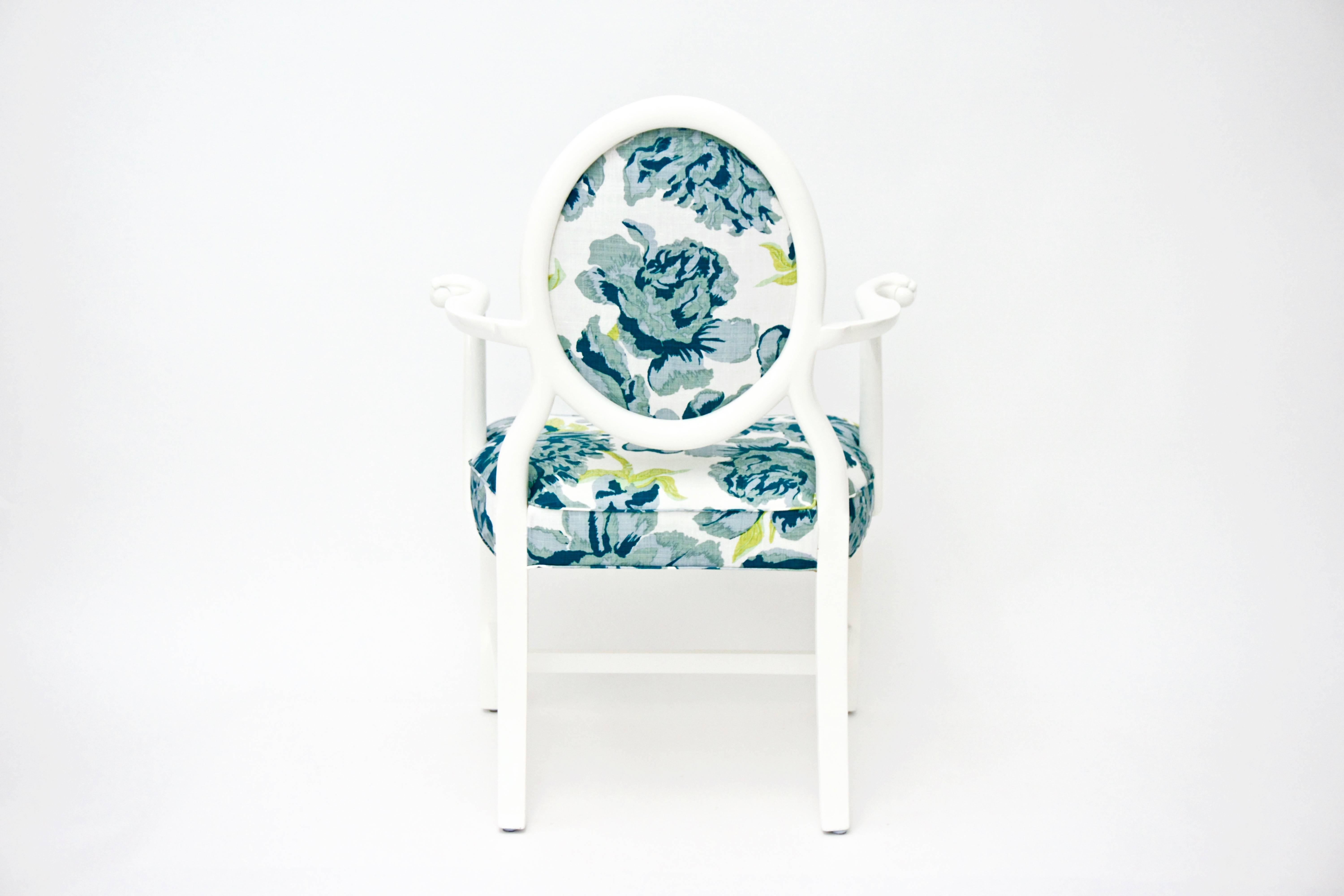 This early 1900s Armchair features ball and claw accent at each arm's end, along with lovely carved details. It has been newly lacquered in white and reupholstered in Cowtan and Tout teal floral over white fabric.

