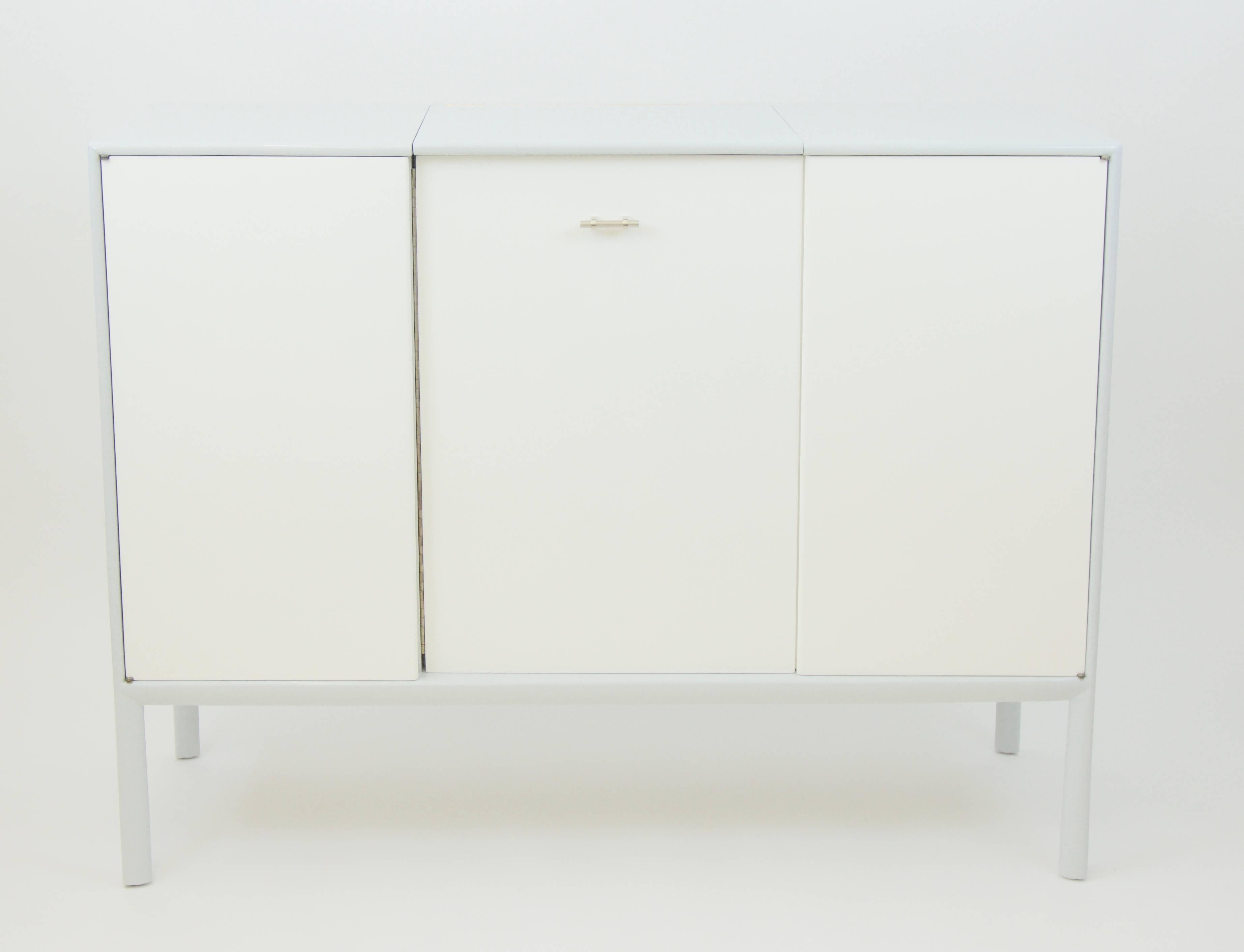 This eight-drawer John Stuart dresser with vanity mirror is newly lacquered. The frame is grey gloss, the doors and drawers are white gloss.
Measures: 52" W x 19" D x 40" H. The mirror is 17" W x 15.5" H.

