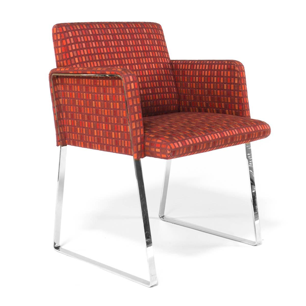 The Stainless collection for Moroso features a flat-bar steel trim outlining the chairs' load-bearing side panels. A clear reference to the Steel collection, designed in the 1990s, with its visible, load-bearing steel square-tube frame. The